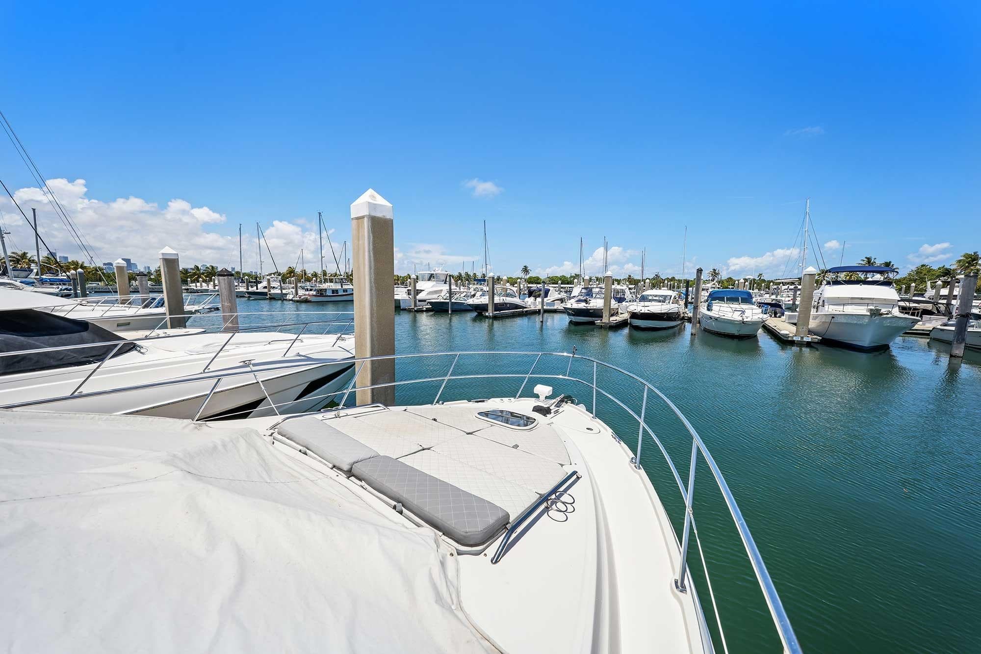 2017 Sea Ray Sundancer 400 docked in a sunny marina with clear blue skies.