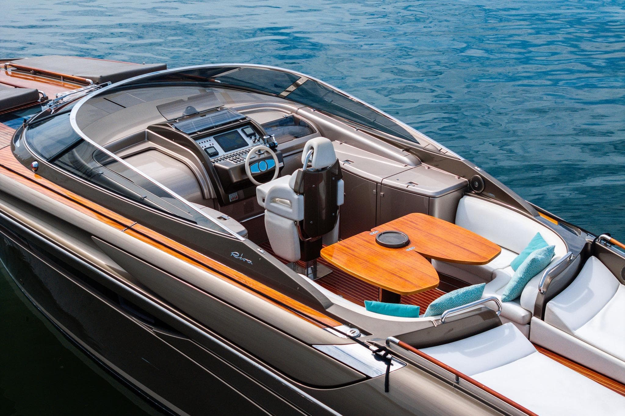 Luxurious 2014 Riva Rivarama yacht with elegant seating and modern dashboard on calm water.
