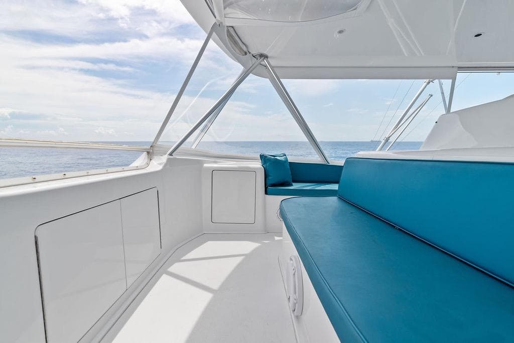 2005 Viking 61 Convertible yacht interior with blue seating and ocean view.
