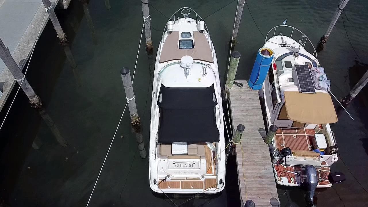 2012 Sea Ray 310 Sundancer docked at marina, aerial view.