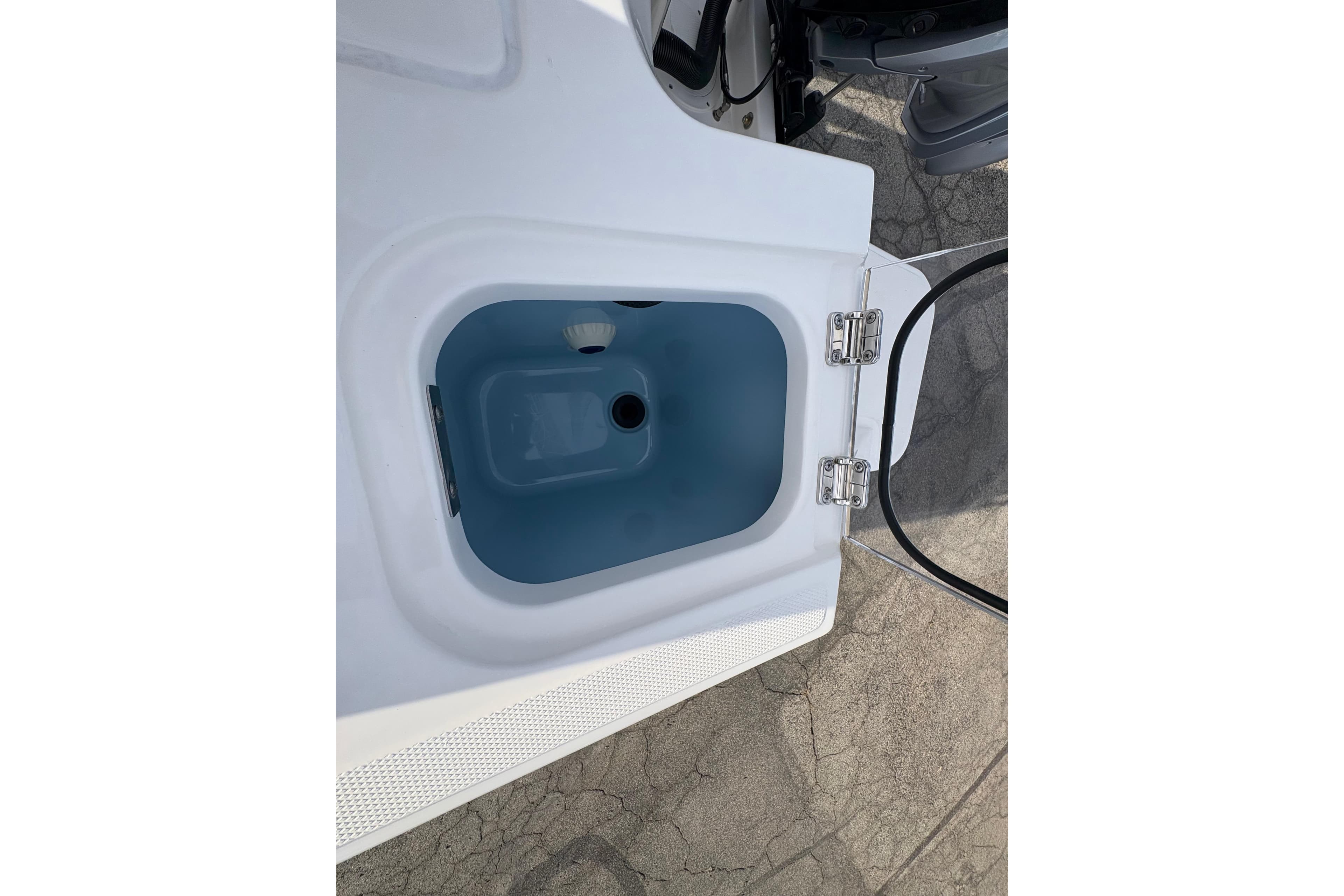 Open storage compartment on 2026 Boston Whaler 240 Vantage boat.