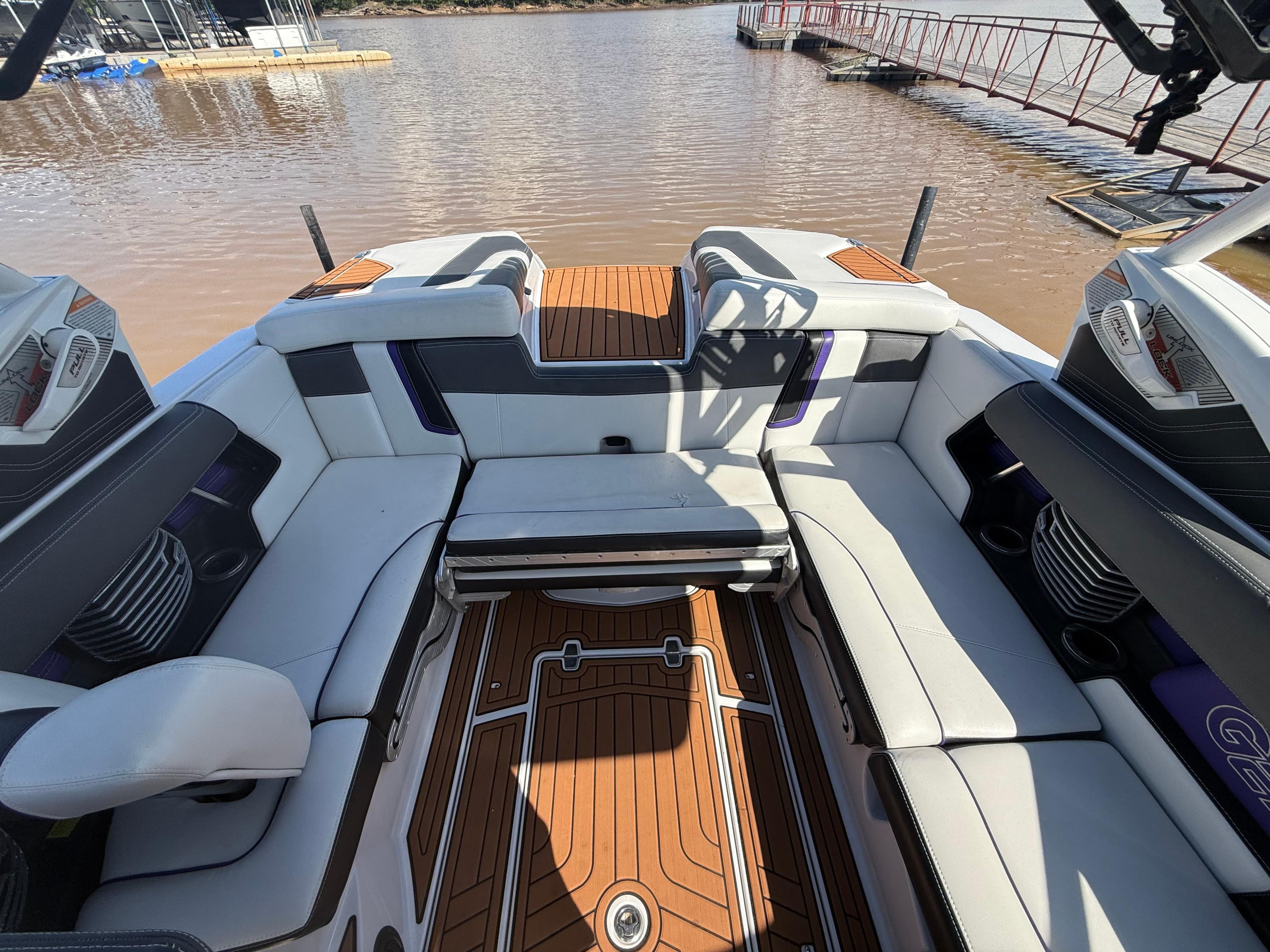 Interior of 2014 Nautique Super Air Nautique G21 boat with luxurious seating and wood flooring.