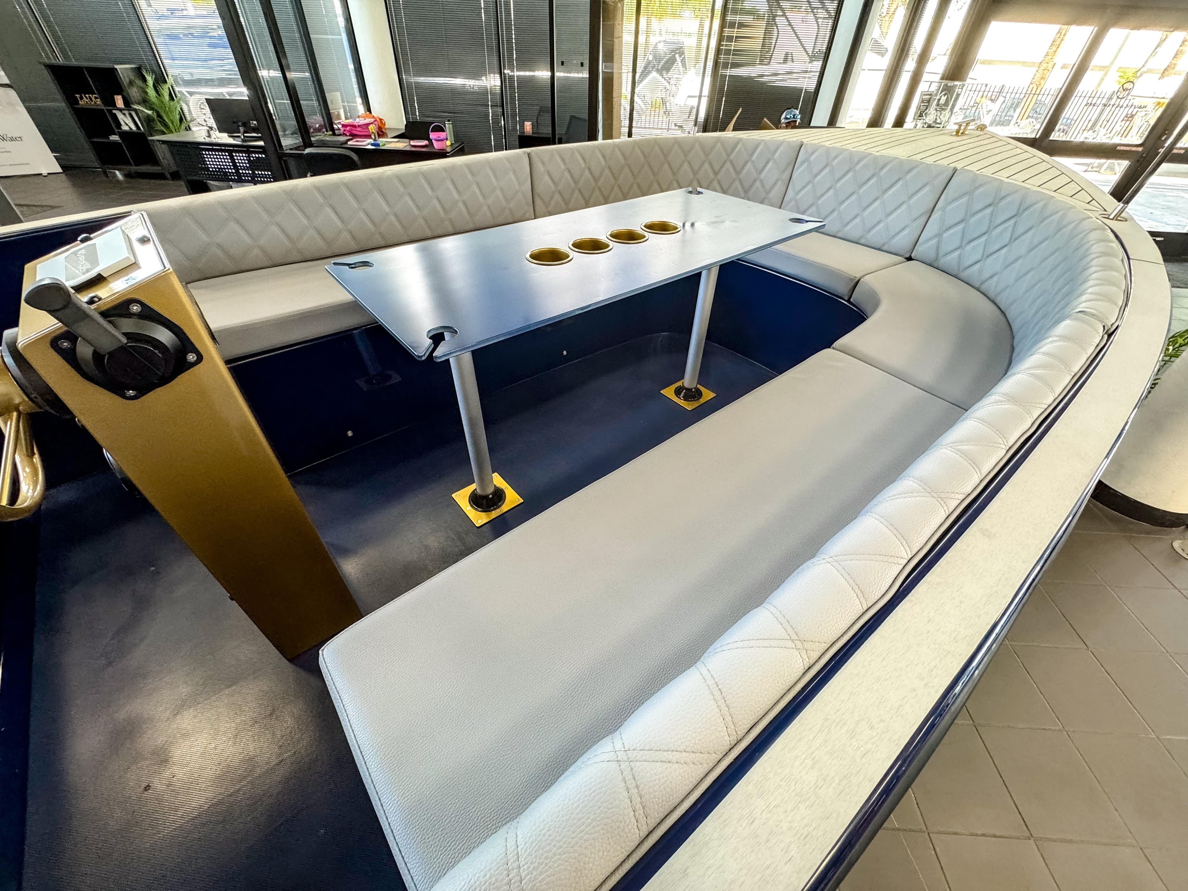 Interior of 2025 Vision Marine Technologies Volt 180 boat with modern seating and table.
