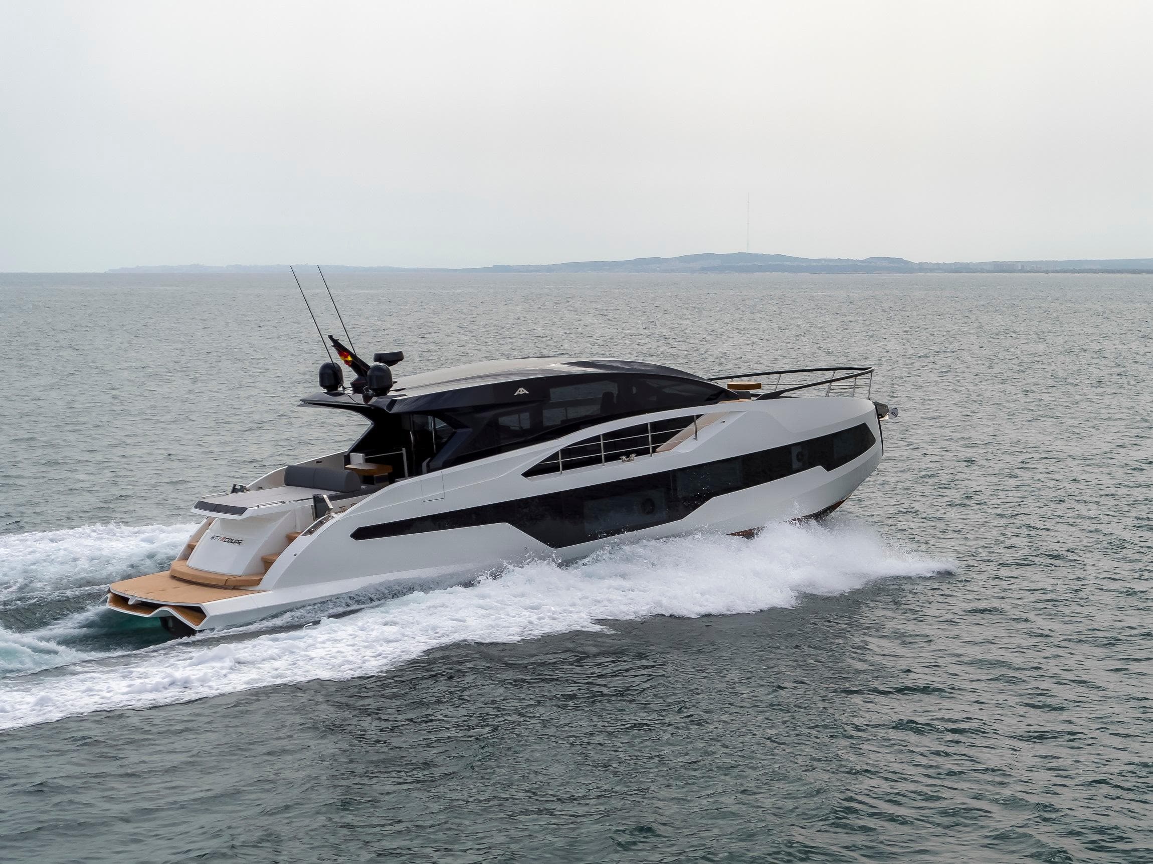 2025 Astondoa 677 Coupe yacht cruising on open water.