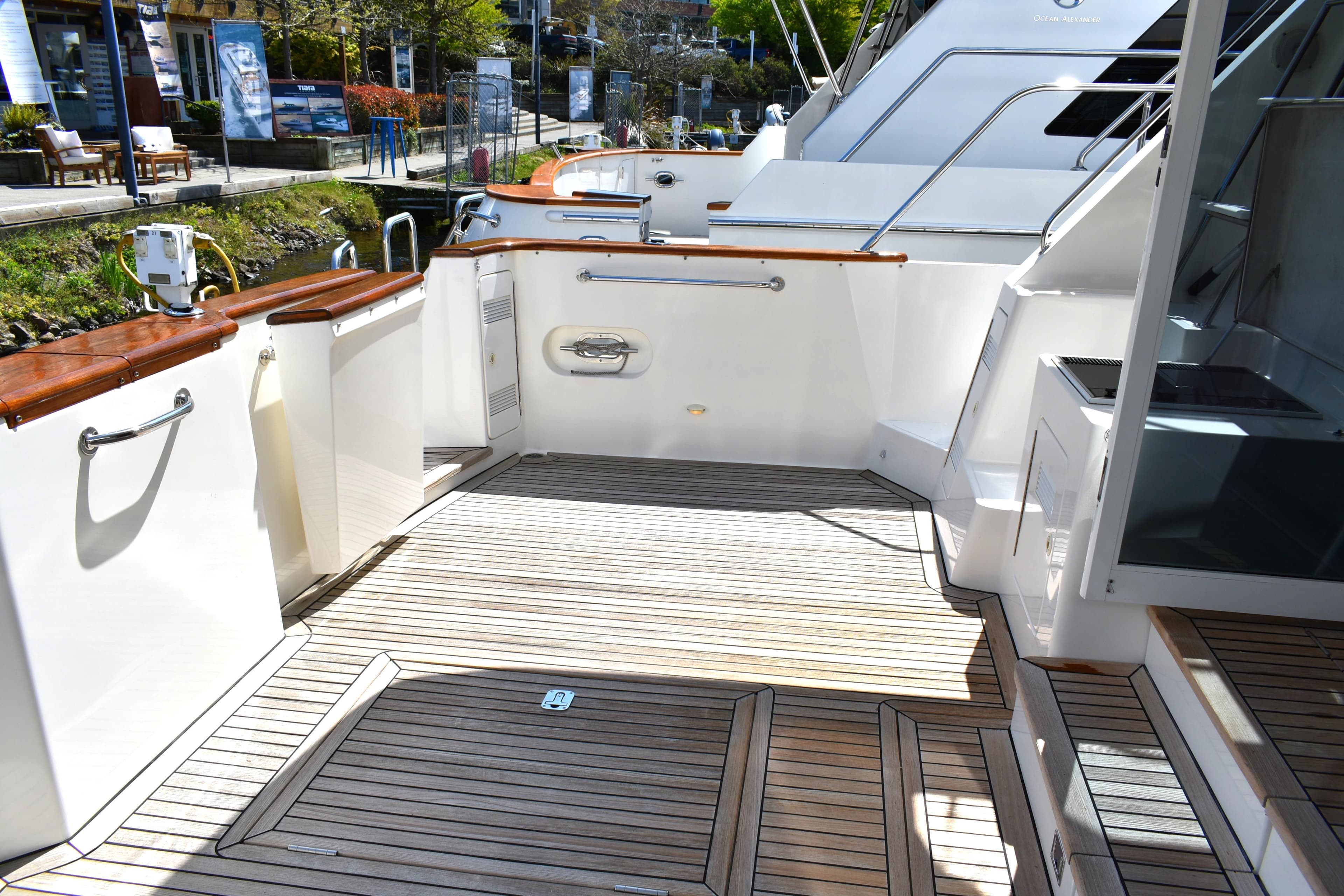 2001 West Bay 58 RPH yacht deck with wooden flooring and sleek design.