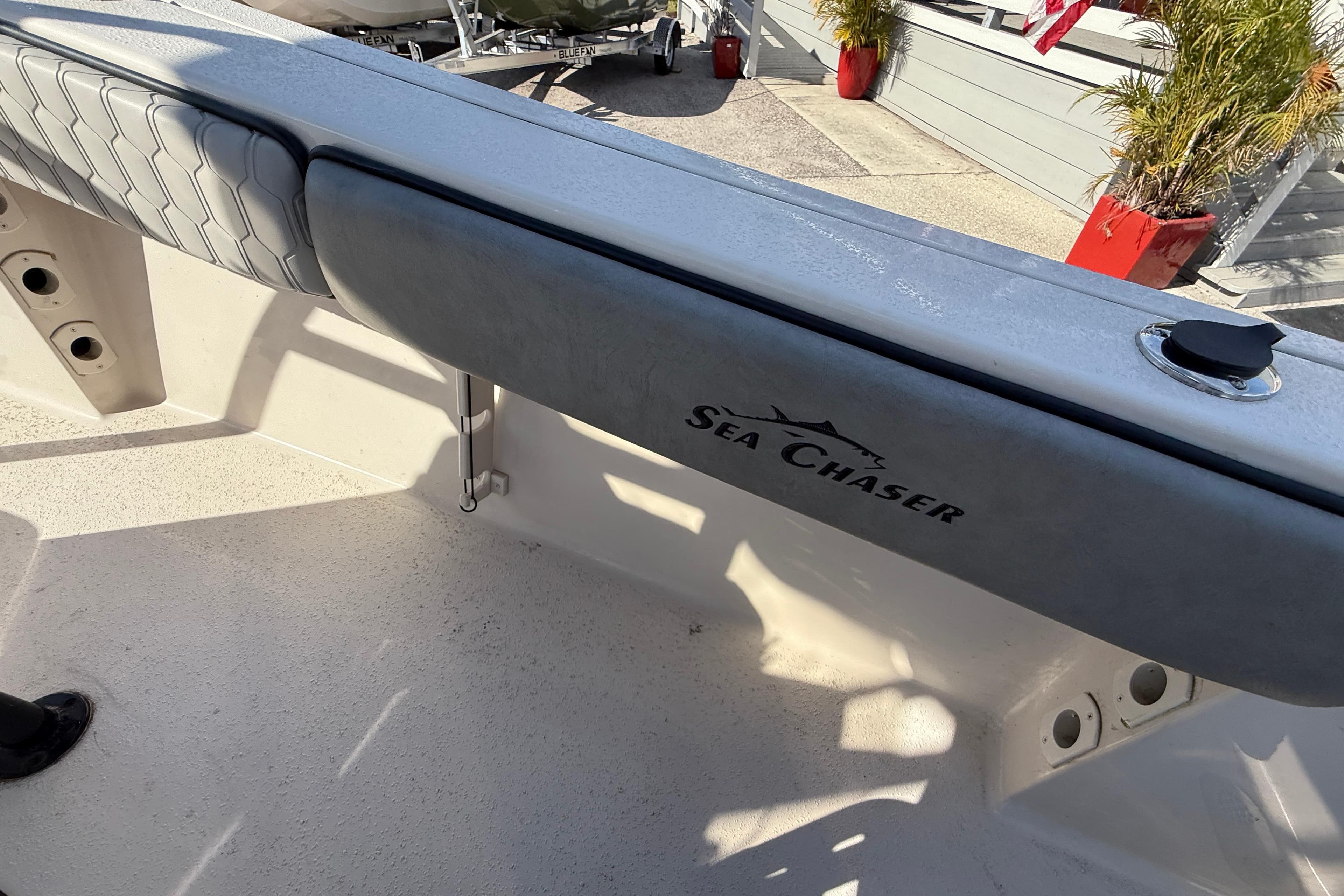 2025 Sea Chaser 22 HFC boat interior with logo and seating detail.