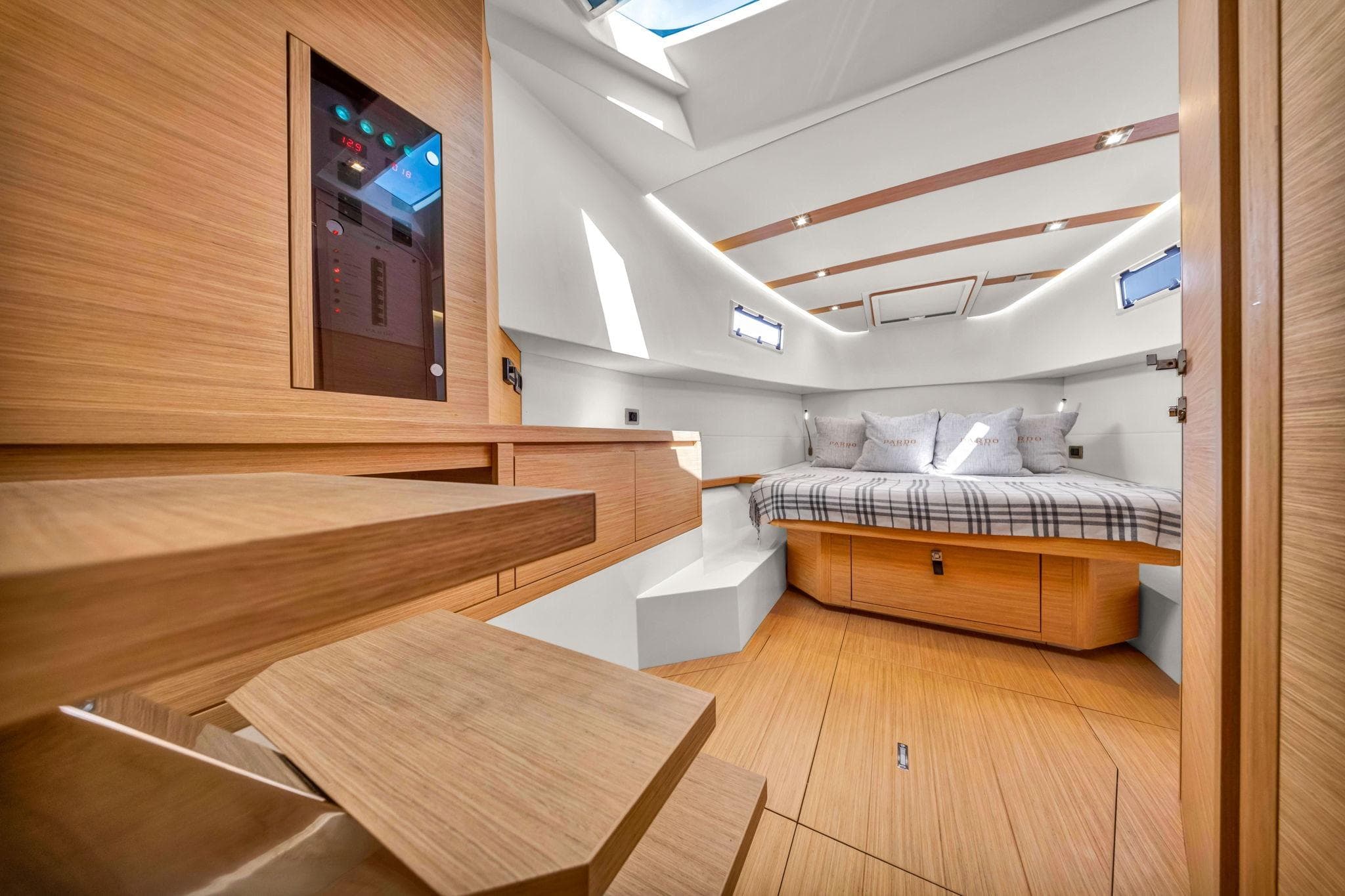 Luxurious interior of 2021 Pardo Yachts 38, featuring a cozy cabin with modern wood finishes.