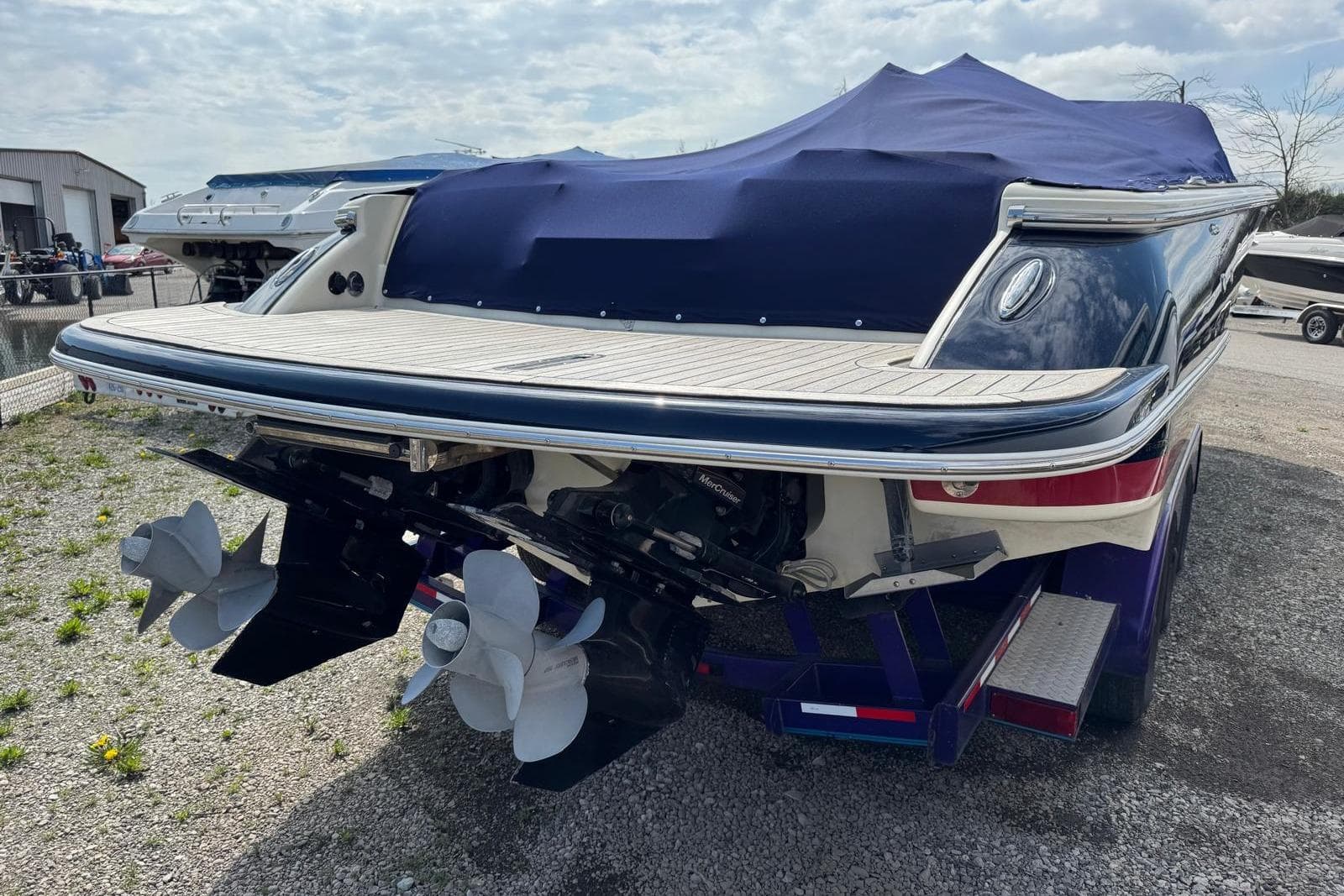 2013 Chris-Craft Launch 28 boat with covered deck and dual propellers.