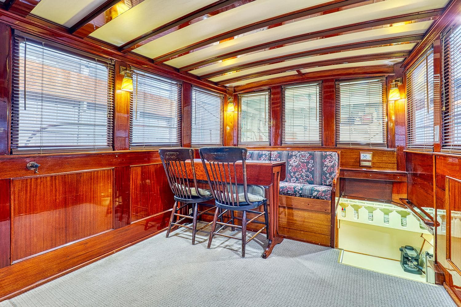 Interior of a 1926 Hacker-Craft Bridge Deck boat with wooden finish.