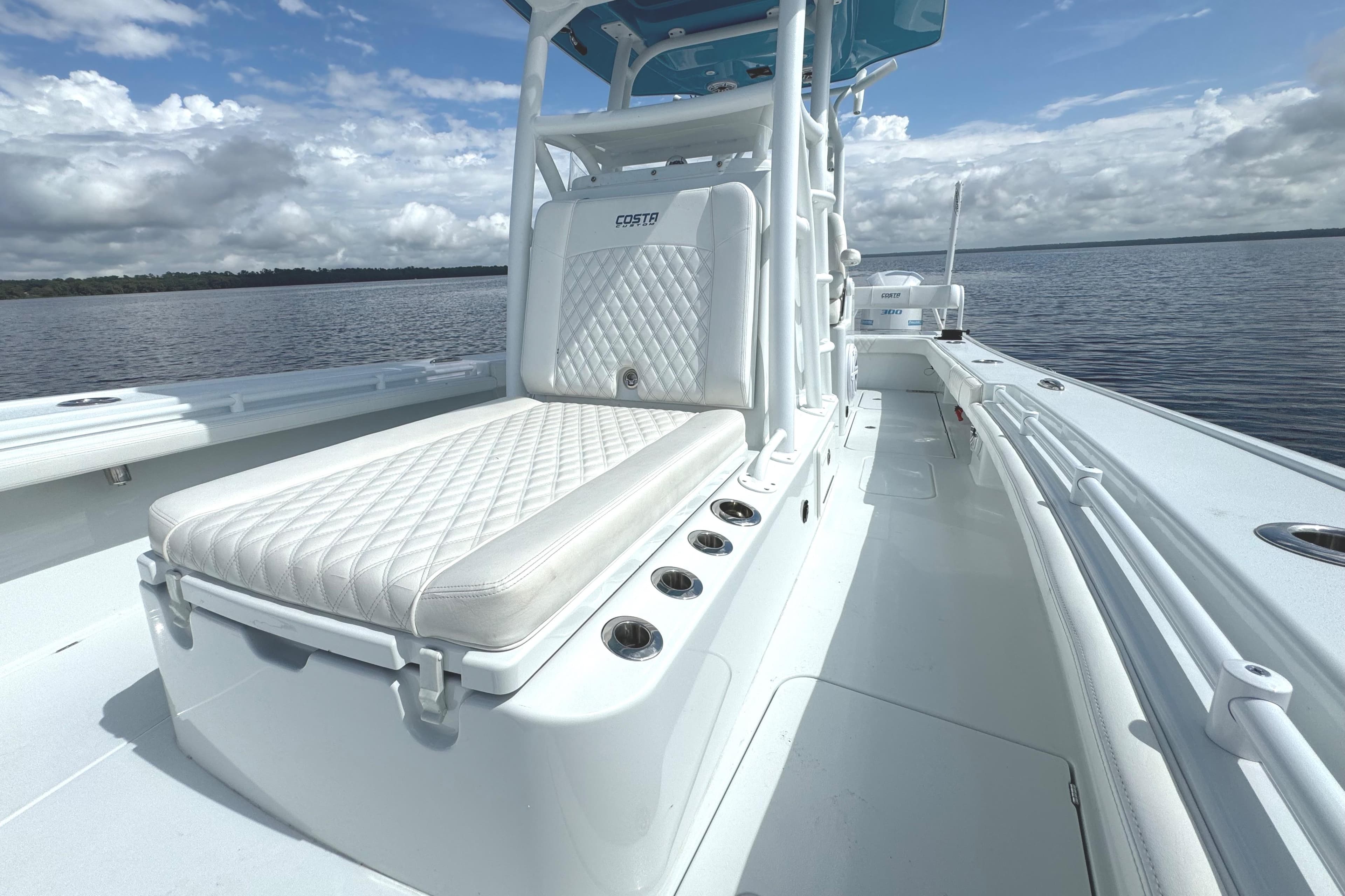 2020 Costa Custom Boats 264 HC on calm water, featuring sleek white seating and modern design.