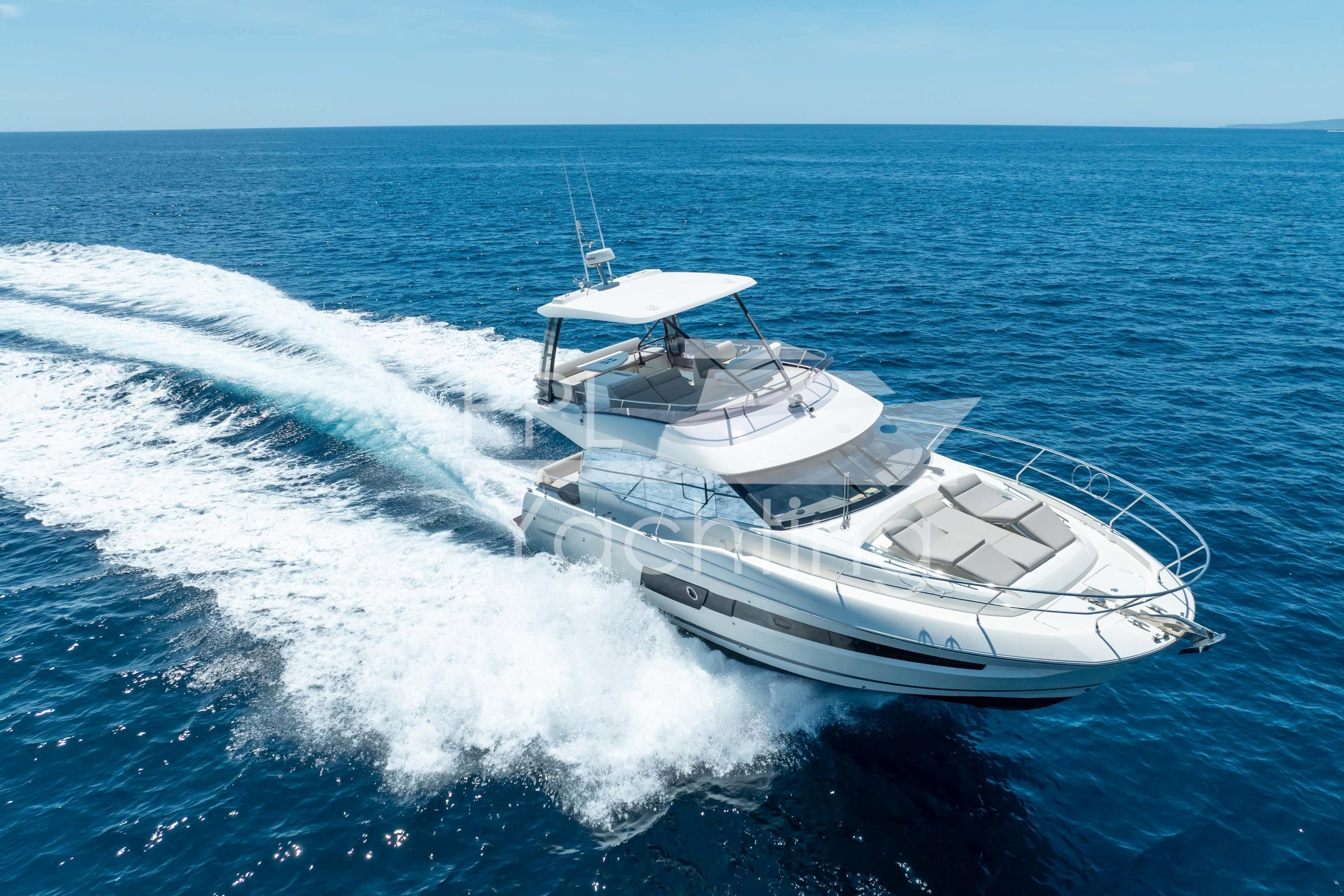 2019 Prestige 460 yacht cruising on open blue sea.