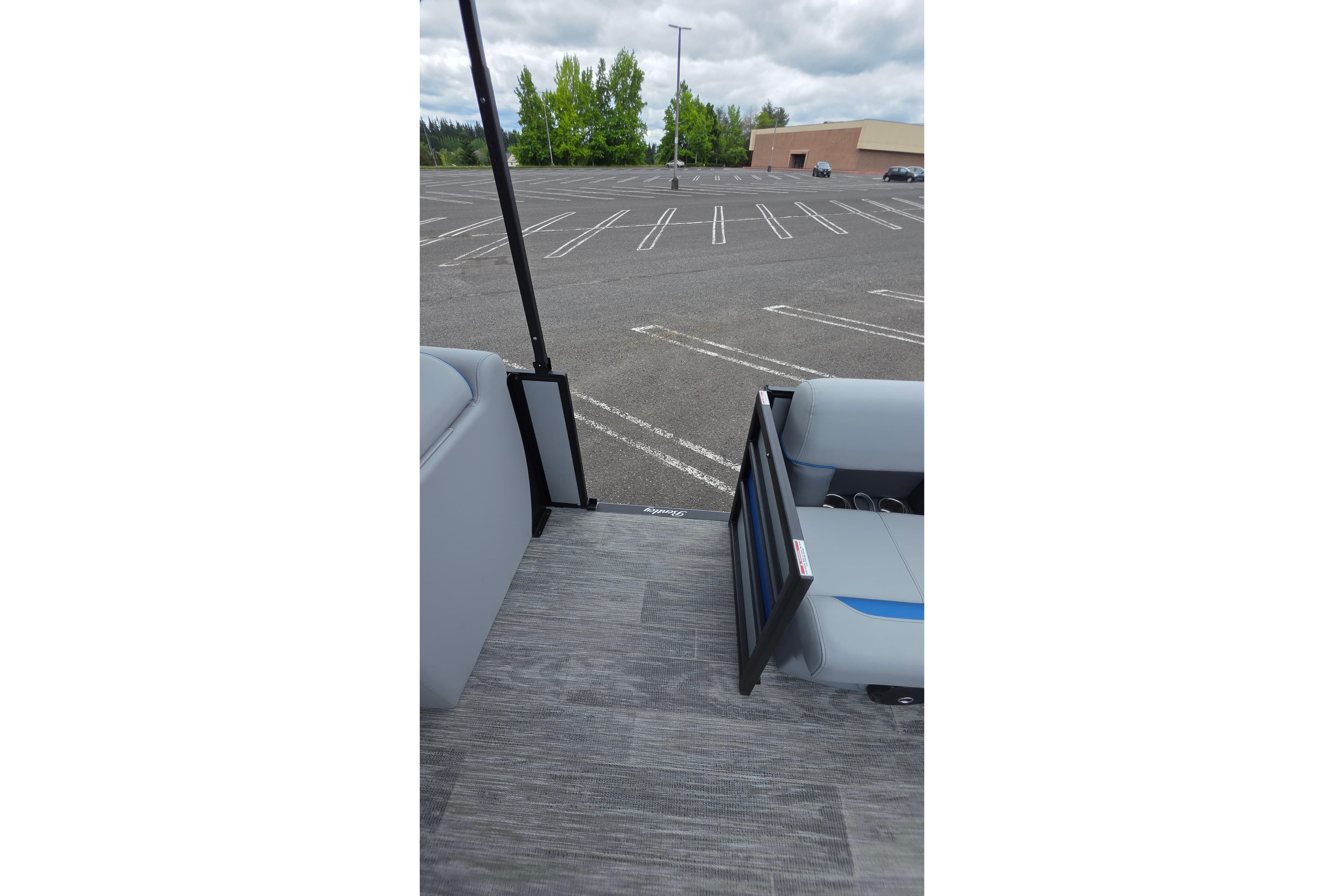 2026 Bentley Pontoons Bolt 203 interior view with open gate in parking lot.