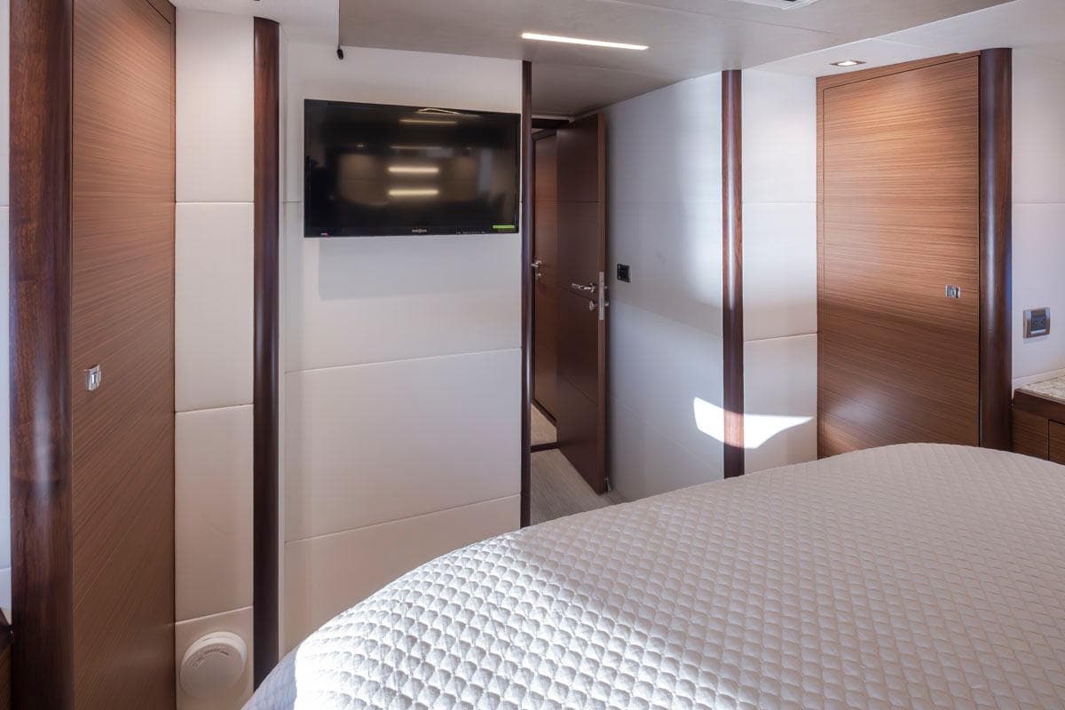 Luxurious interior of 2017 Ocean Alexander 70e yacht with modern wood paneling and wall-mounted TV.