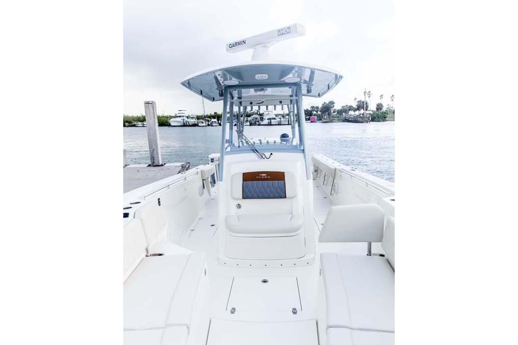 Manufacturer Provided Image: 2025 Cobia 320 Center Console boat docked by the water.