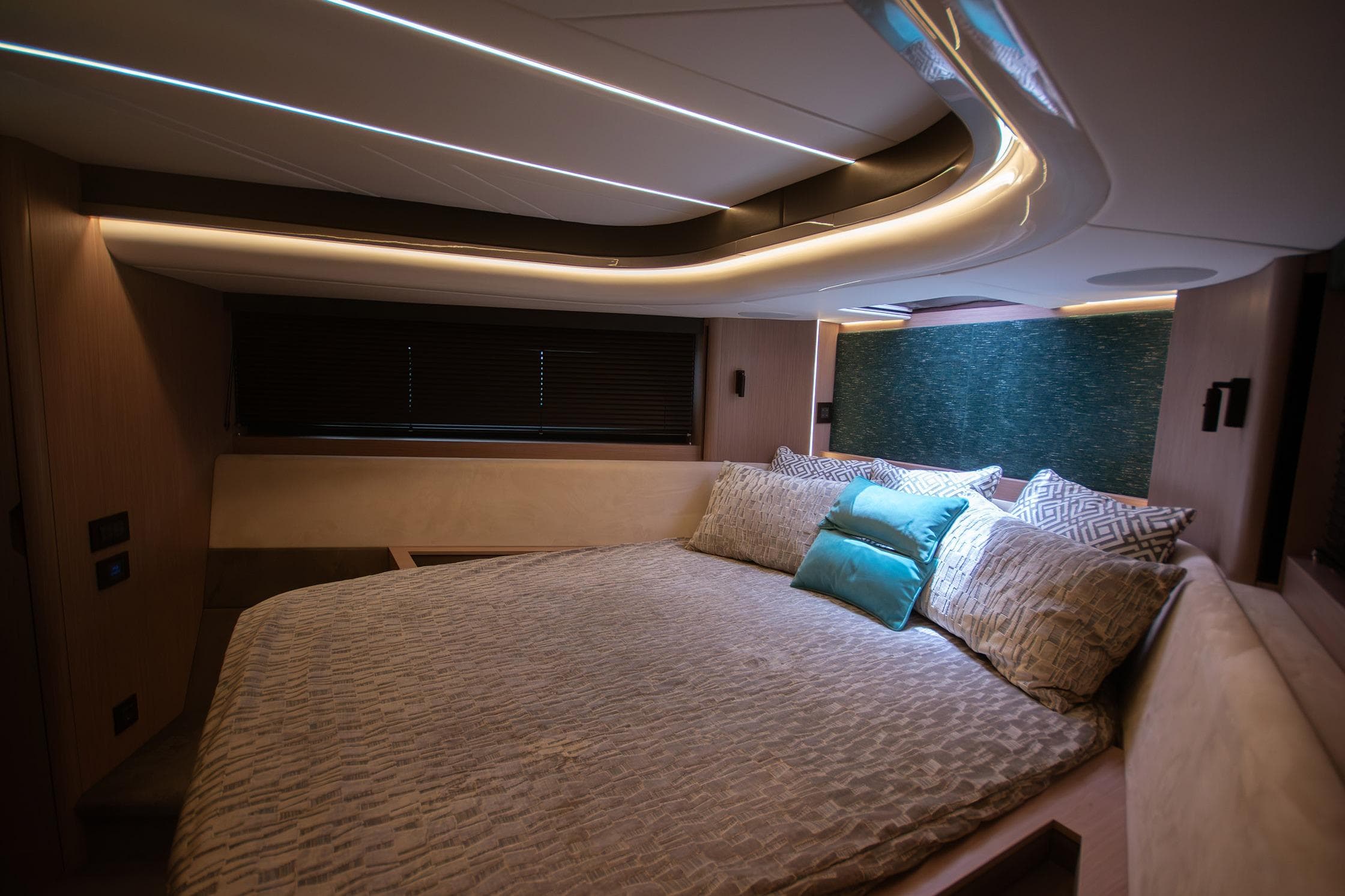 Luxurious bedroom interior of 2024 Sunseeker Superhawk 55 yacht with modern lighting.