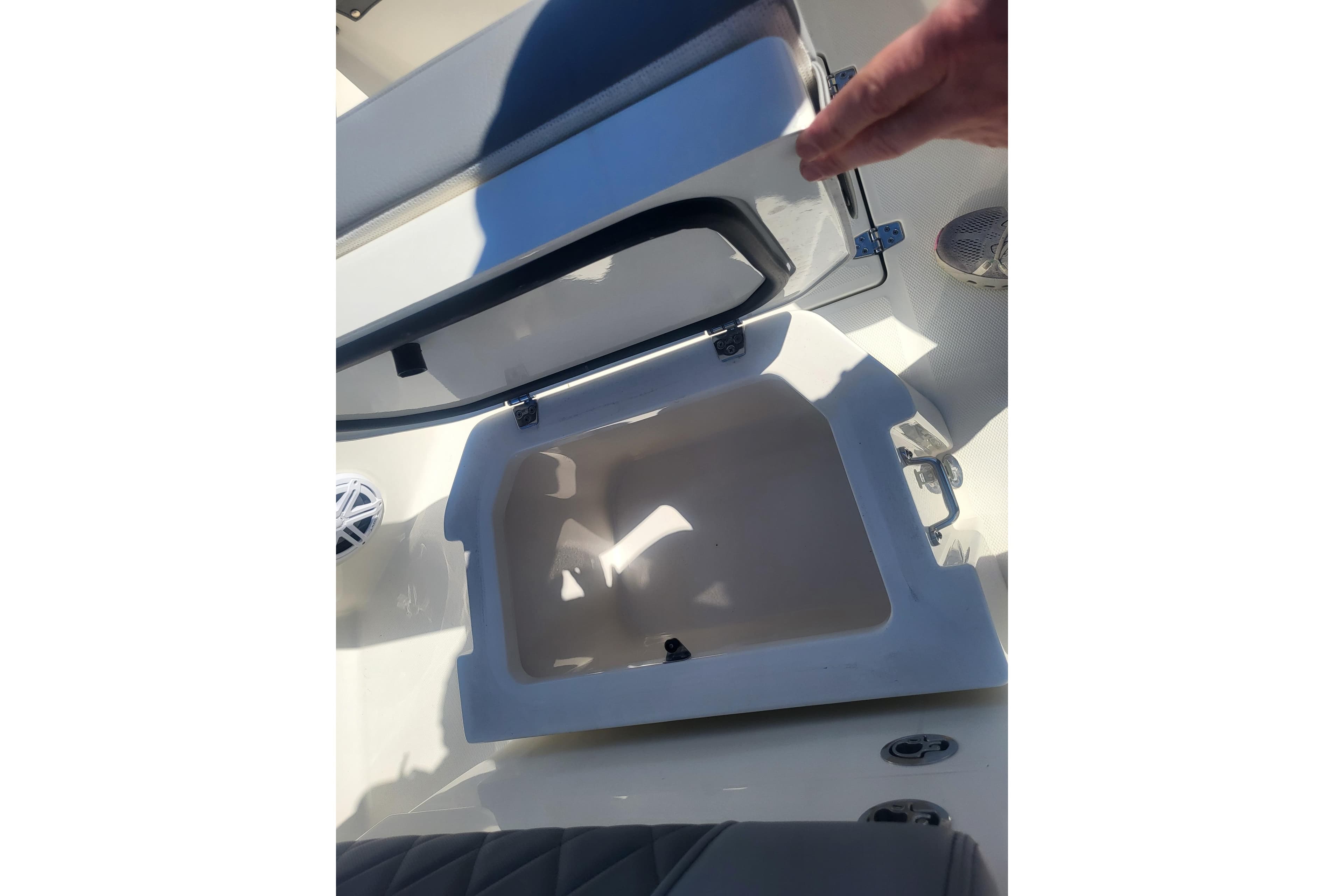 Open storage compartment on 2024 Pathfinder 2200 TRS boat, showcasing interior space.