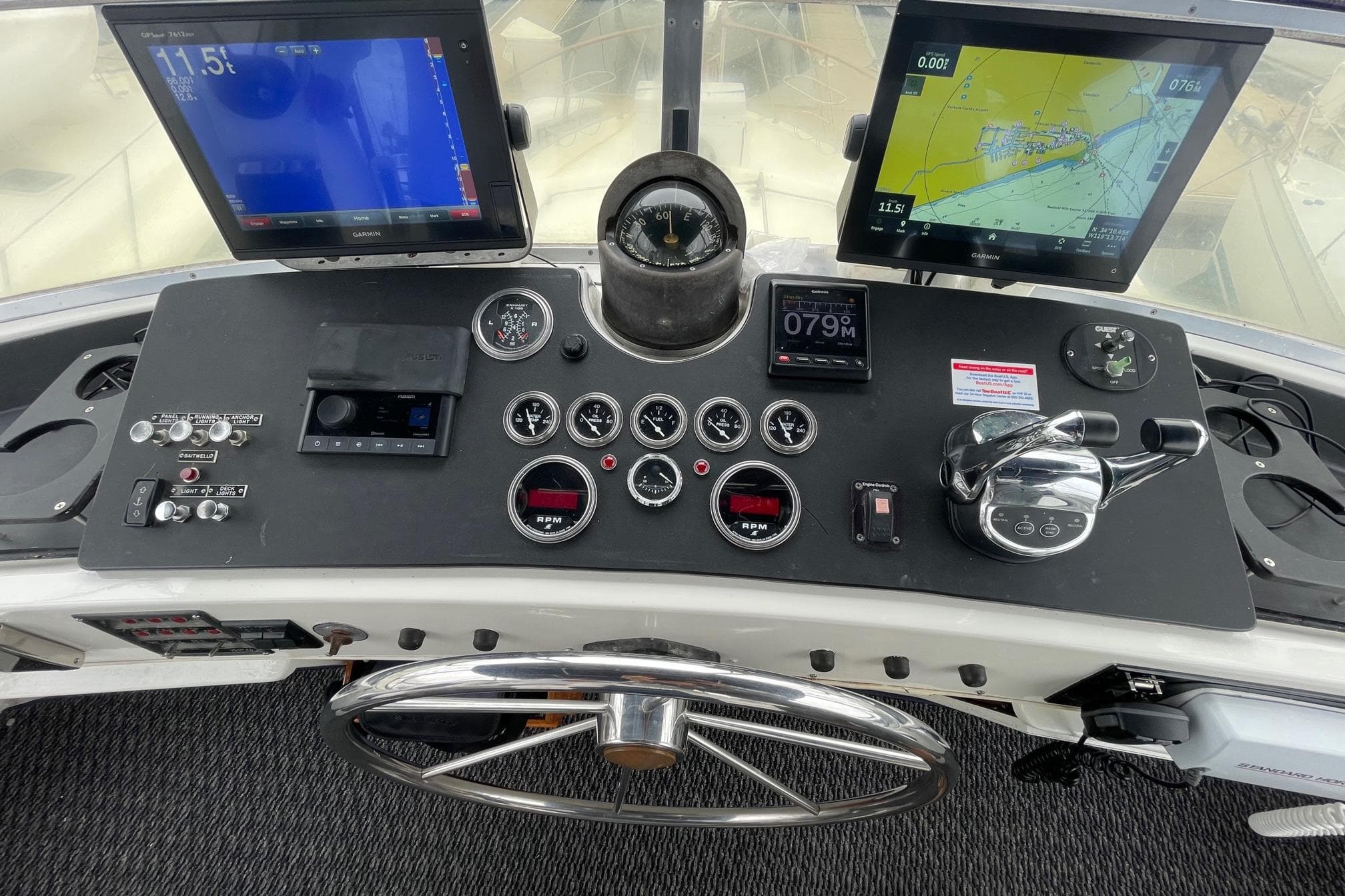 Cockpit of 1975 Uniflite Sport Fisher 42 with navigation screens and controls.