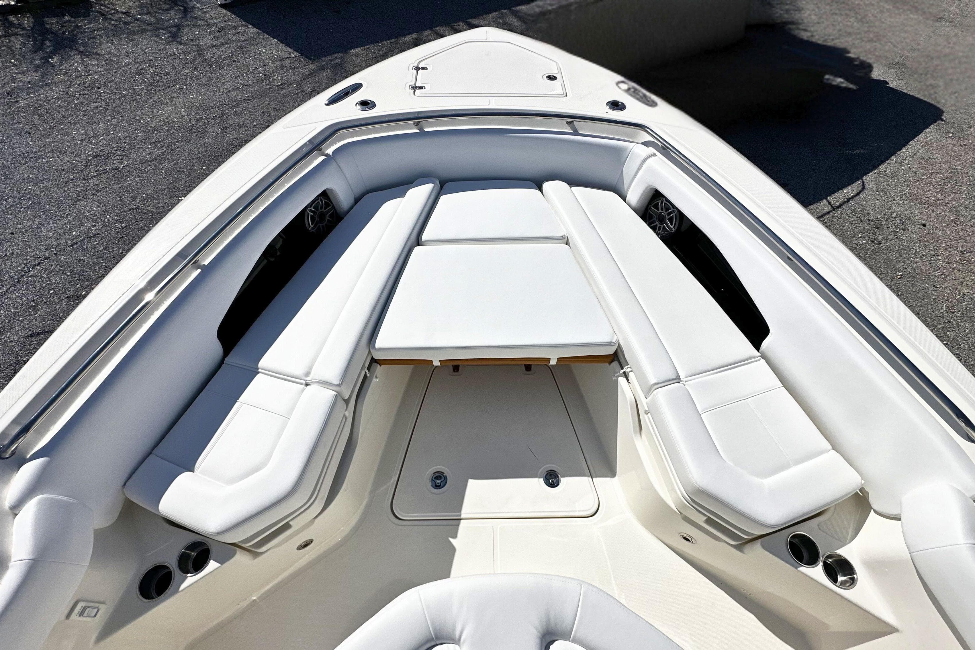 Luxurious seating area on 2026 Boston Whaler 360 Outrage boat, featuring white upholstery.