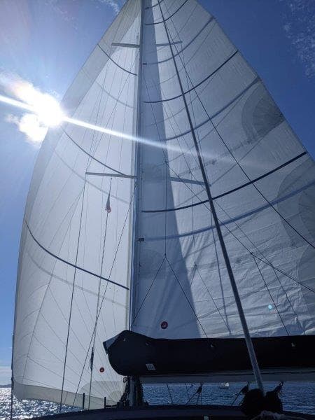 Jeanneau Sun Magic 44 sailboat under blue sky, year 1990.
