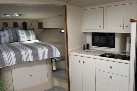 1998 Cruisers 3870 Express interior with bed, kitchenette, and microwave.