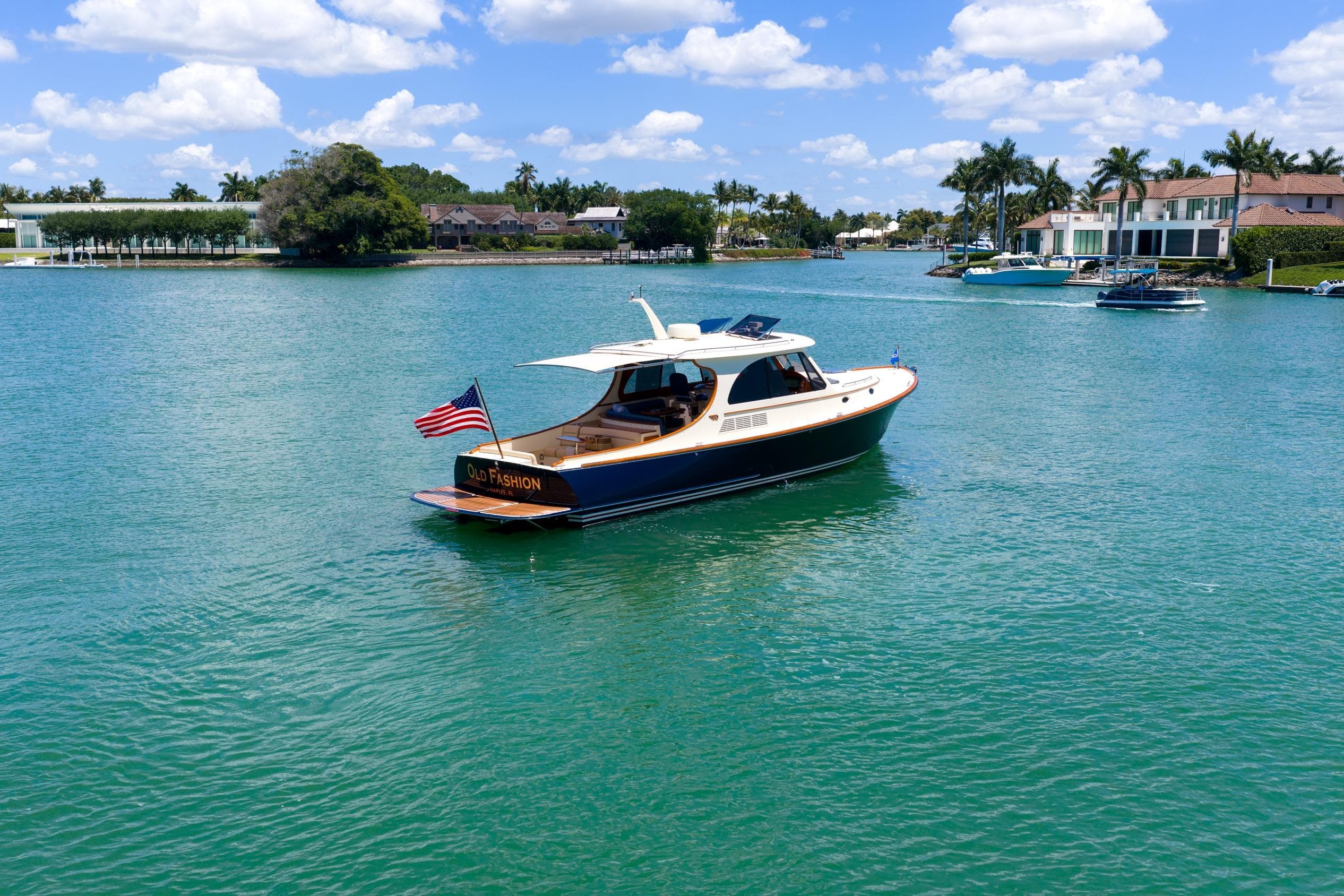 2020 Hinckley Picnic Boat 40 cruising on a sunny day in a scenic waterway.