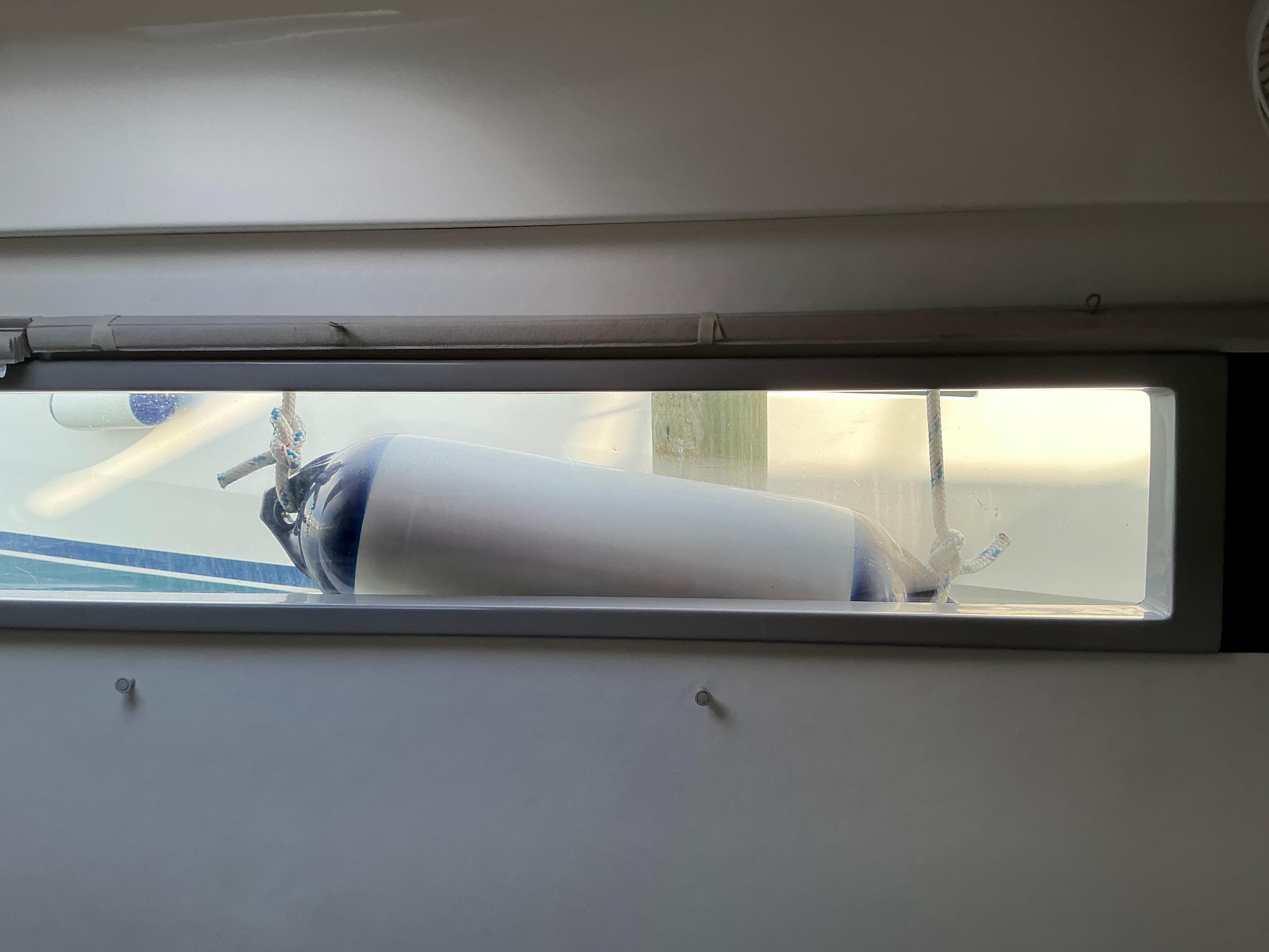View from Leopard 51 Powercat 2019 window showing a boat fender outside.