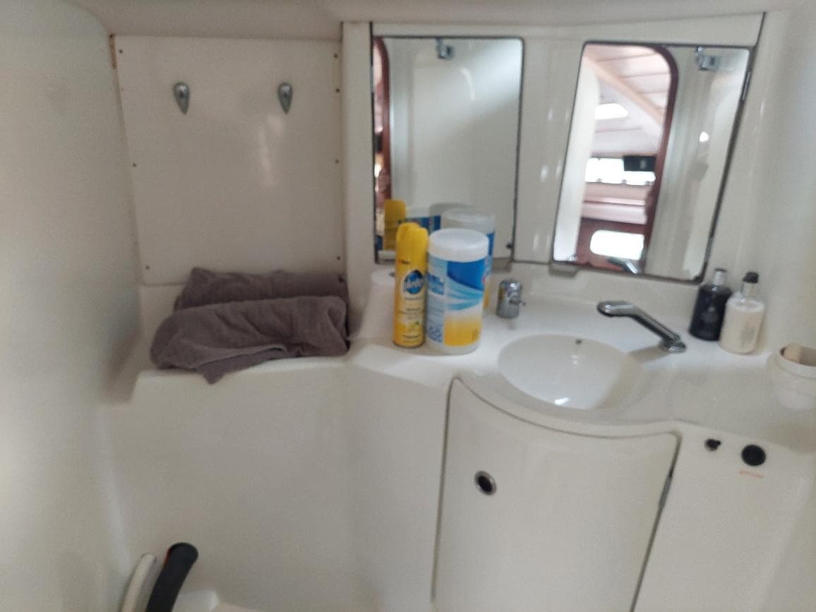 Bathroom interior of 1995 Beneteau Oceanis 351 yacht with sink and toiletries.