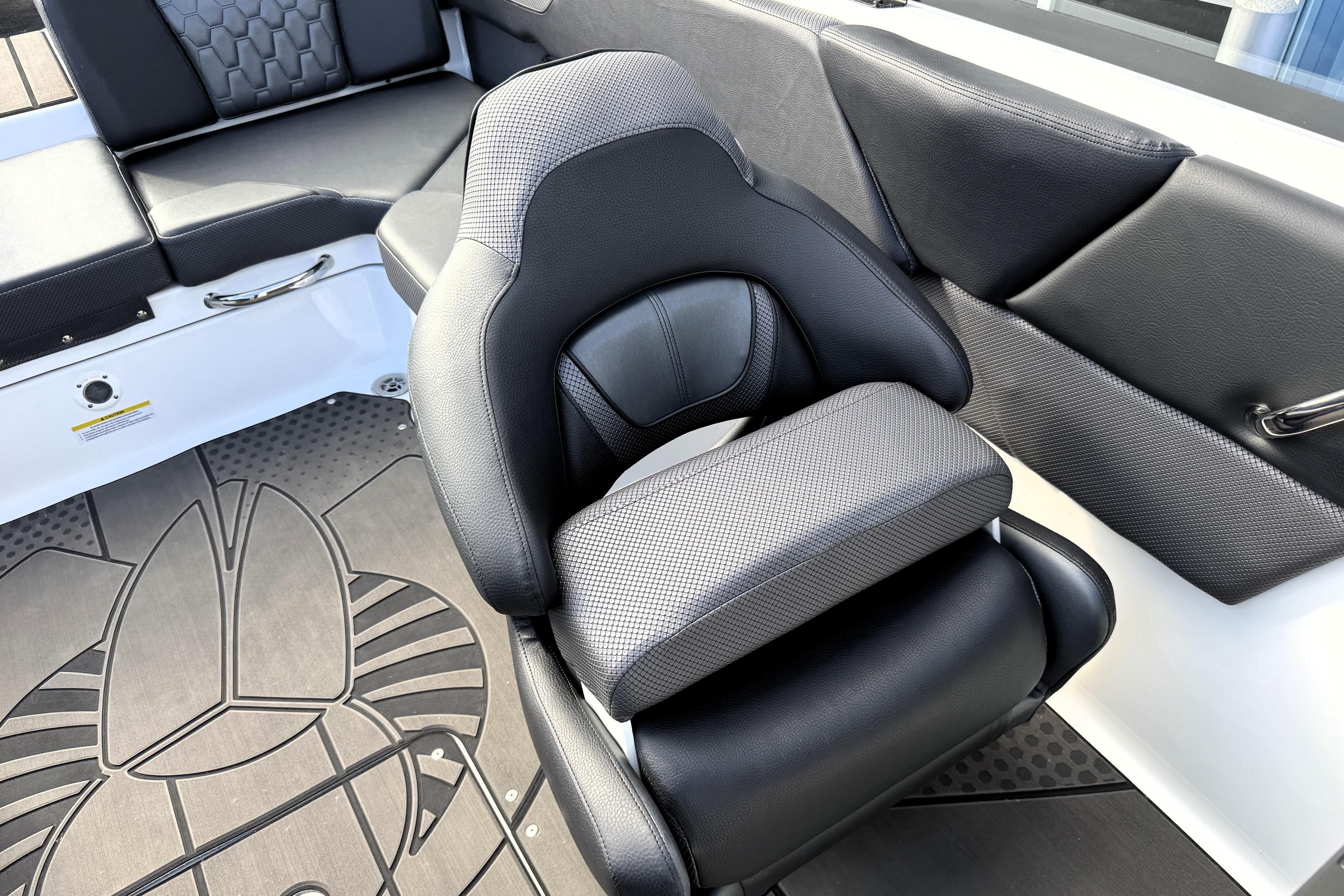 2026 Scarab 210 LX boat interior with black seating and stylish flooring design.