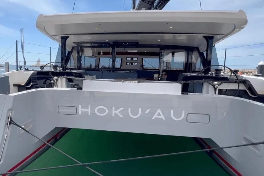 2025 HH Catamarans HH44 yacht, rear view, docked with visible steering wheels and deck.