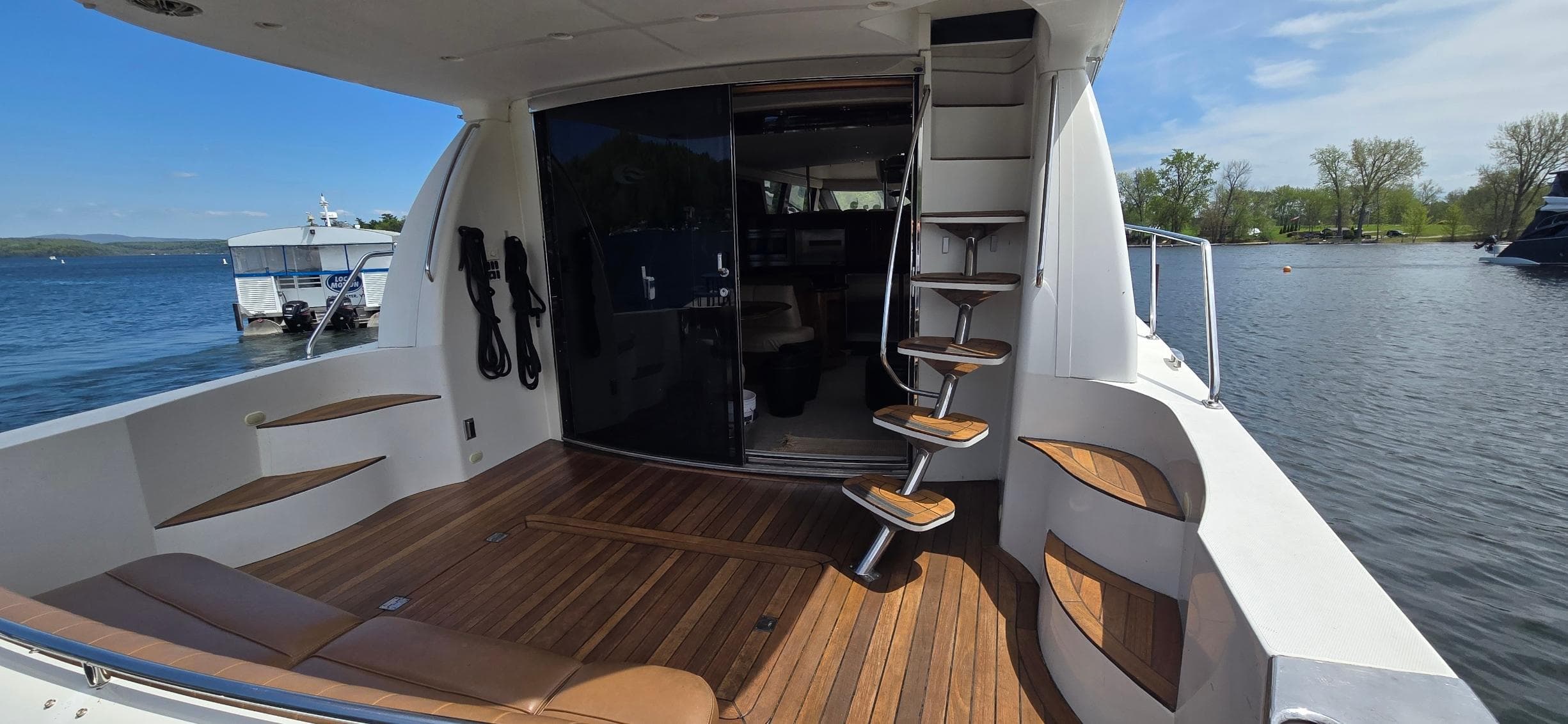 2005 Carver 560 Voyager yacht deck with wooden flooring and spiral staircase.
