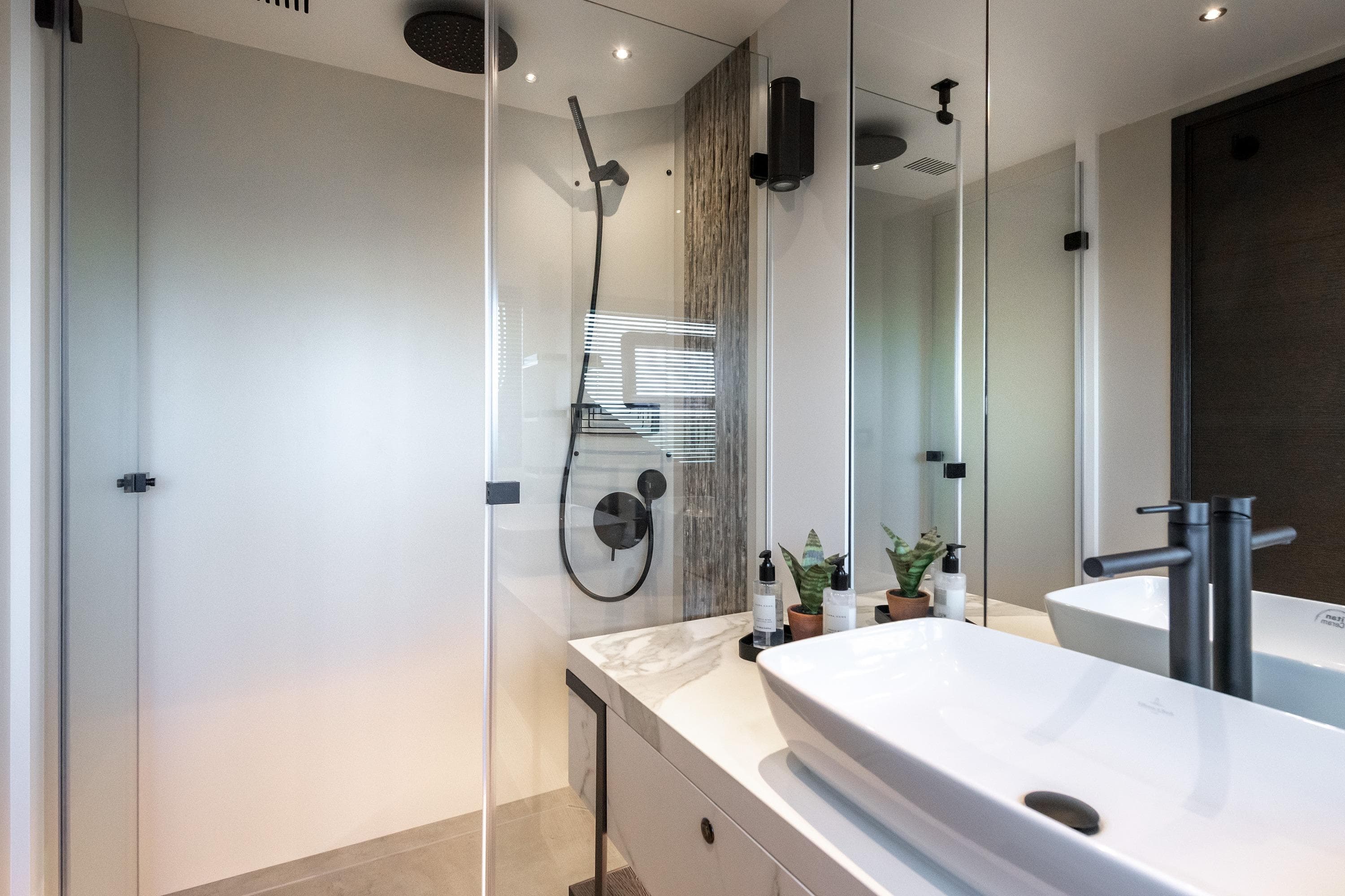 Modern bathroom in 2025 Numarine 22xp yacht with sleek fixtures and elegant design.