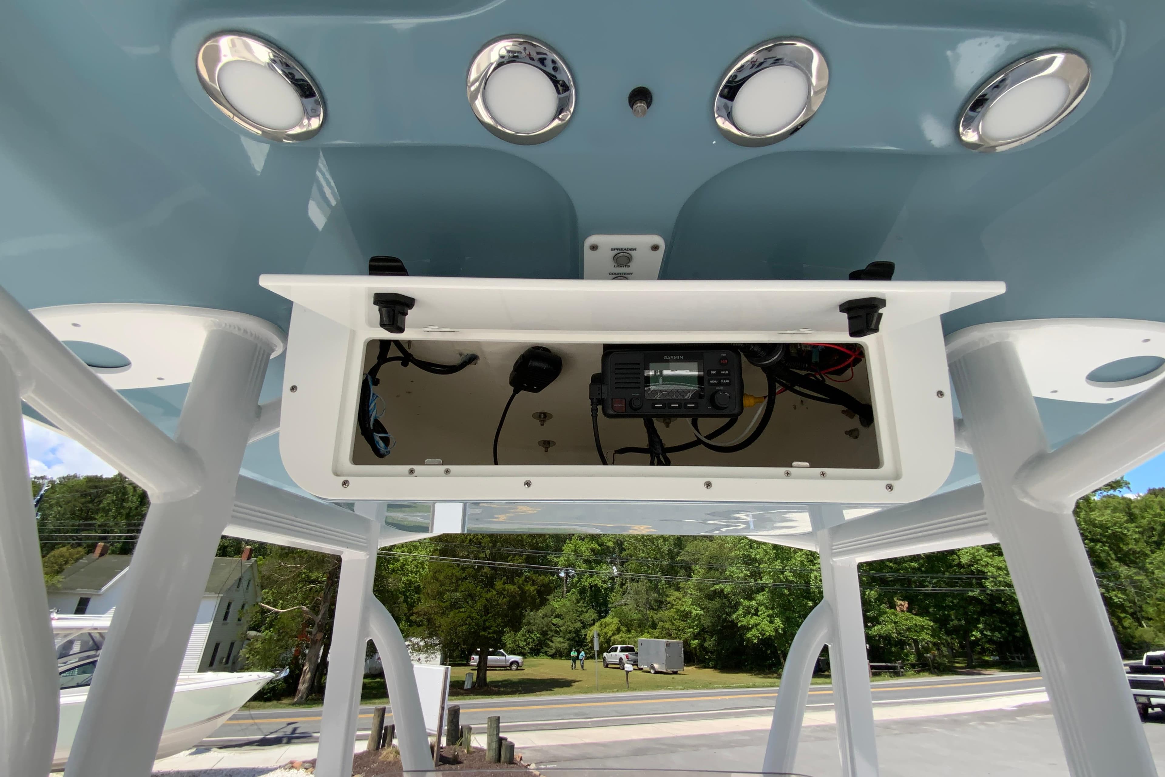 2024 Sea Hunt Ultra 234 boat console with electronic equipment and overhead lighting.