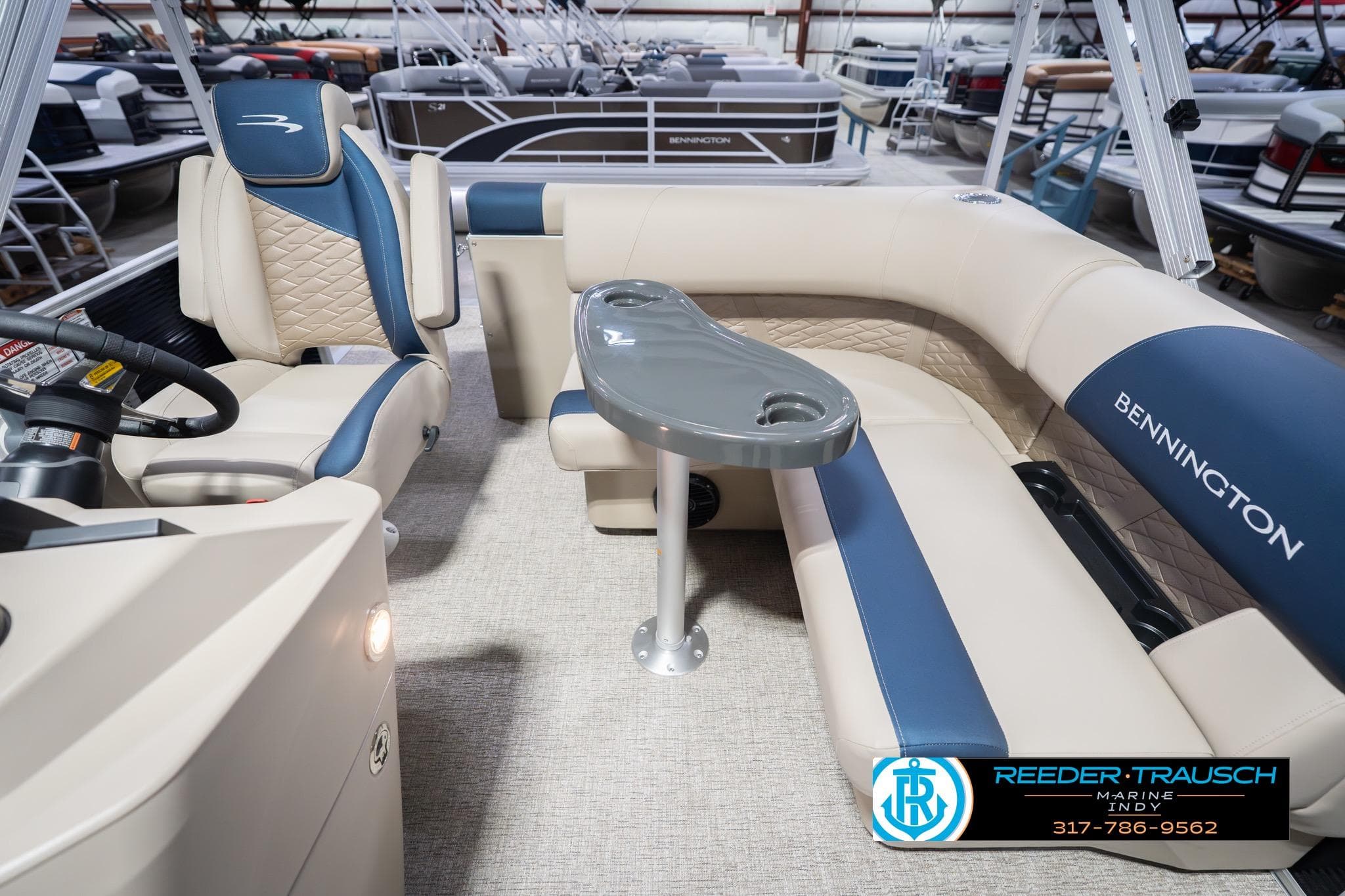 2026 Bennington 168 SLJ pontoon boat interior with beige and blue seating.