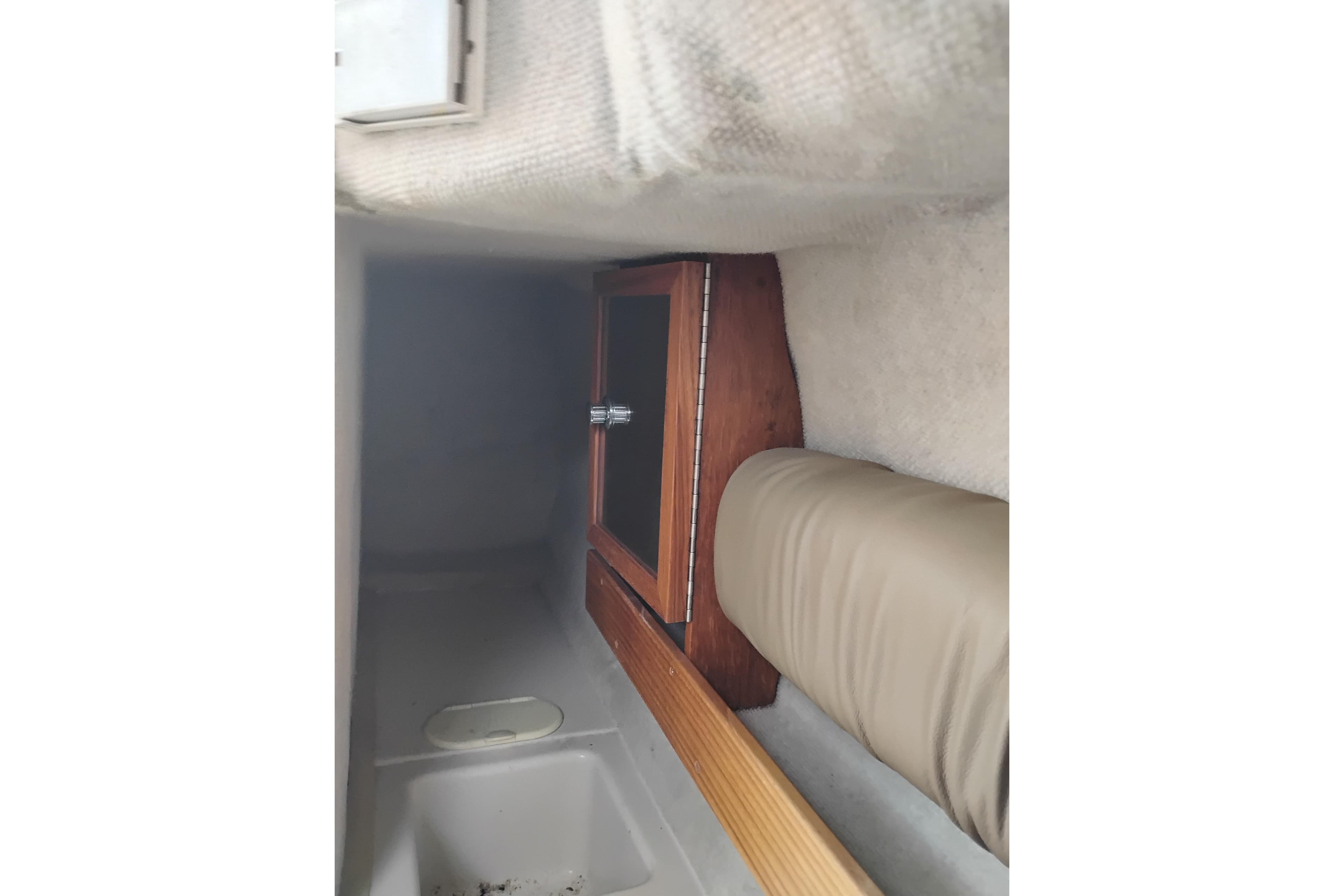 Interior cabin of 2007 Glacier Bay 2685 Coastal Runner with wooden cabinet and cushioned seating.