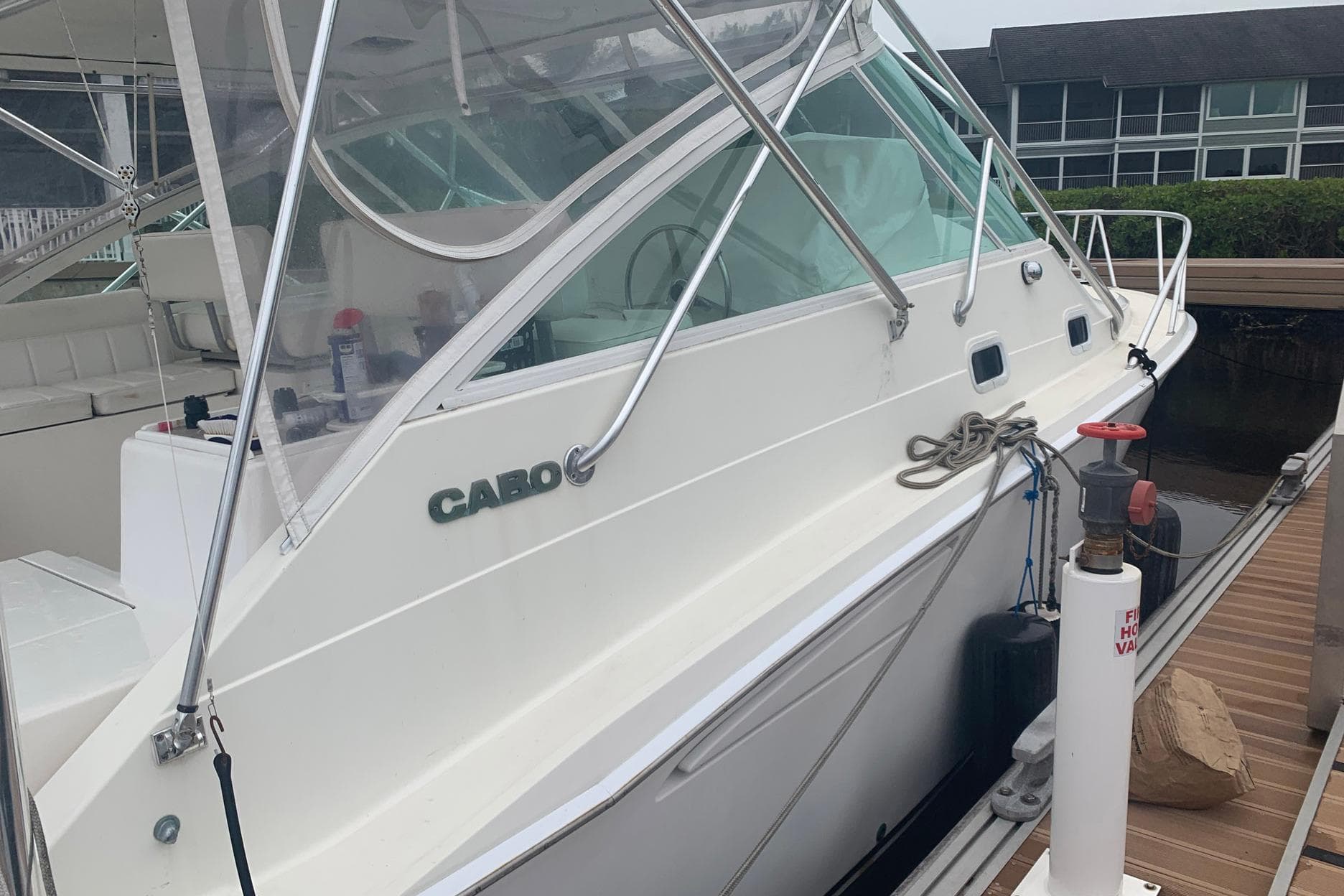 2002 Cabo 35 Express boat docked, featuring sleek design and spacious interior.