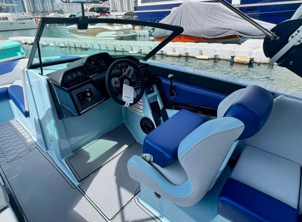 2023 MasterCraft NXT22 boat interior with blue and white seating, docked at marina.