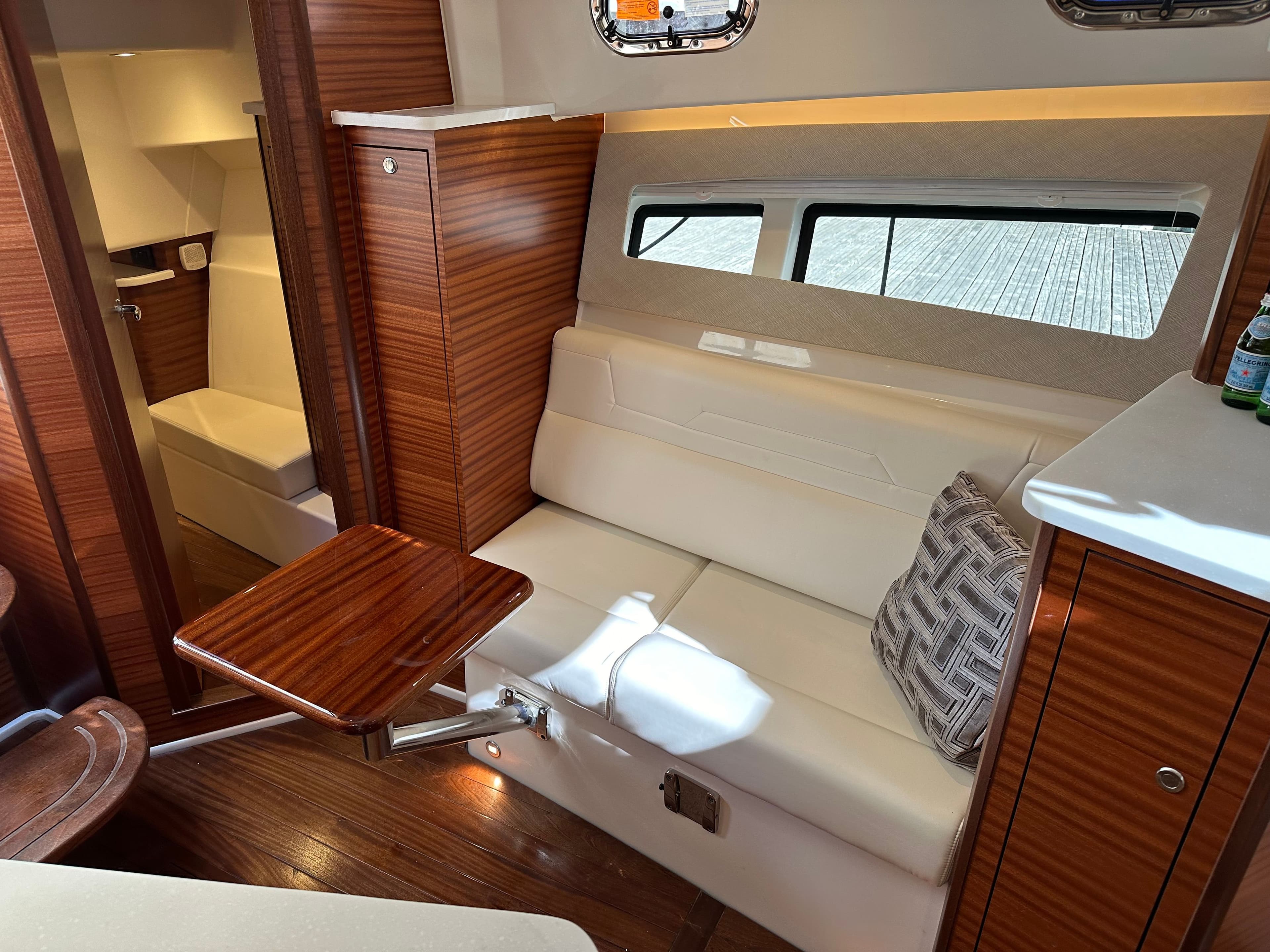 Interior of 2024 Pursuit OS405 yacht with elegant wood paneling.
