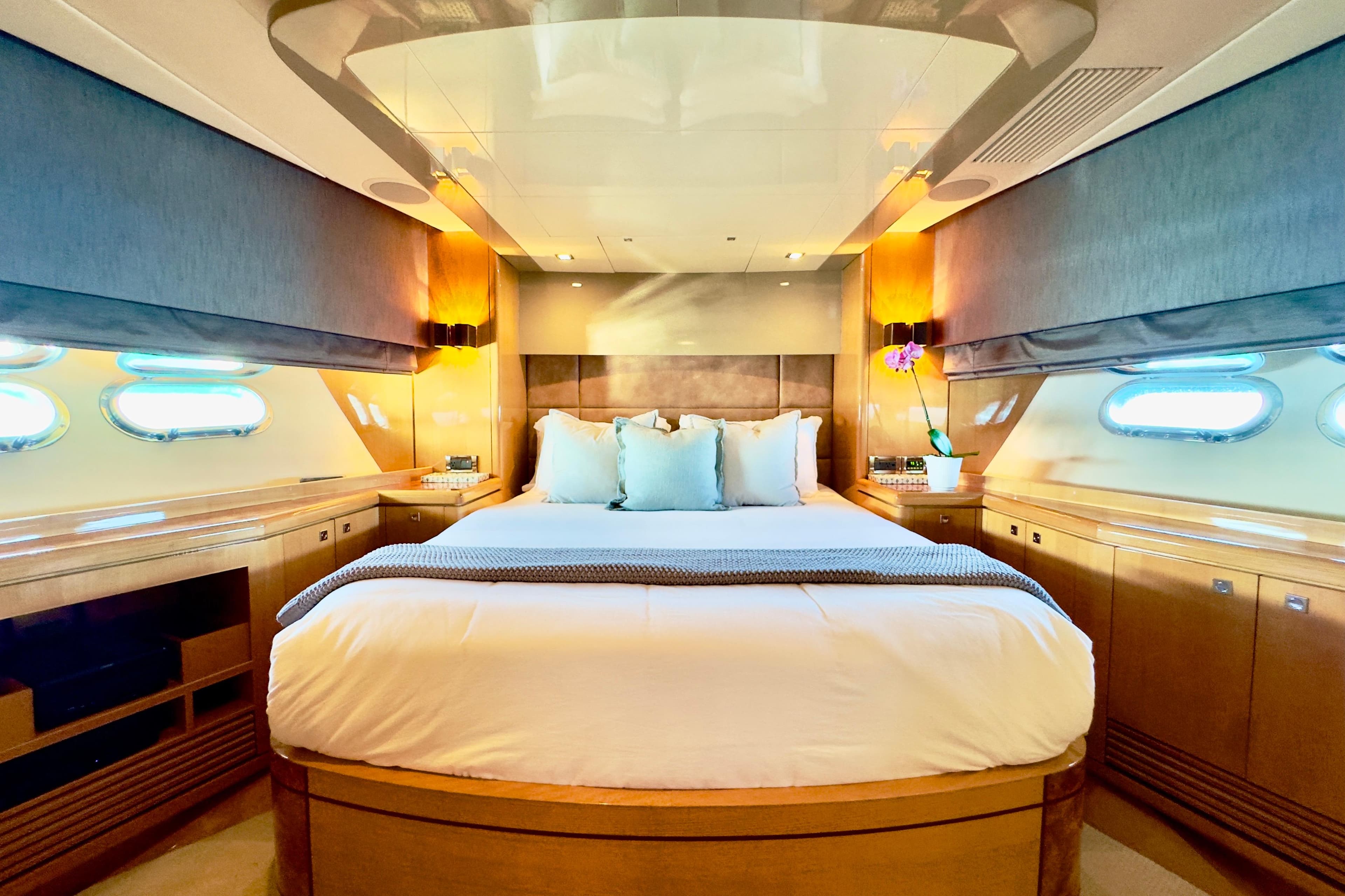 Luxurious bedroom interior on 2011 Horizon E88 yacht with elegant wood finishes.