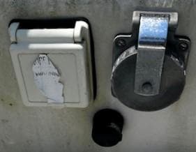Electrical outlets on a 1986 Pearson 303 boat, featuring protective covers.