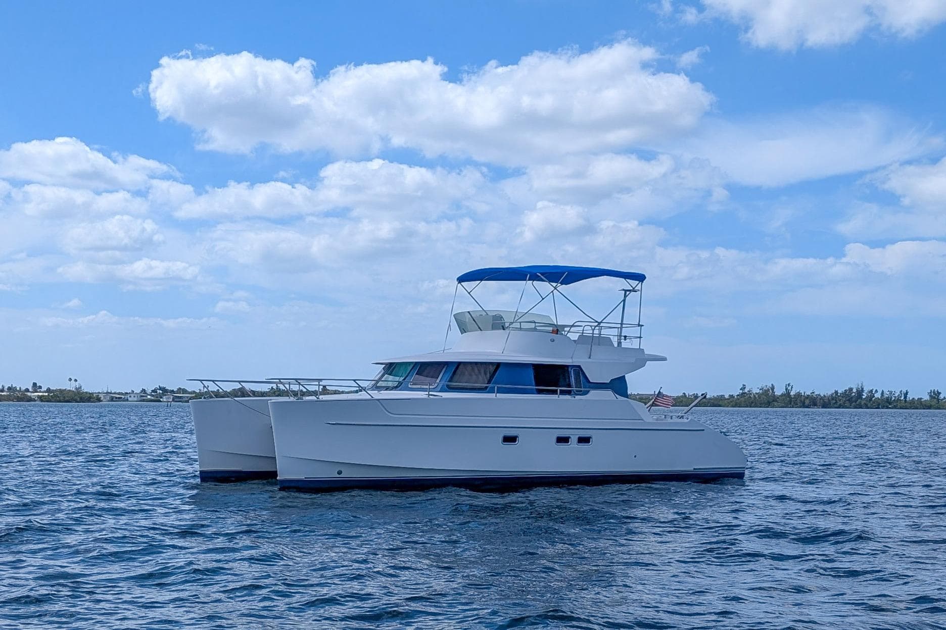 2003 Fountaine Pajot Maryland 37 catamaran on calm waters.