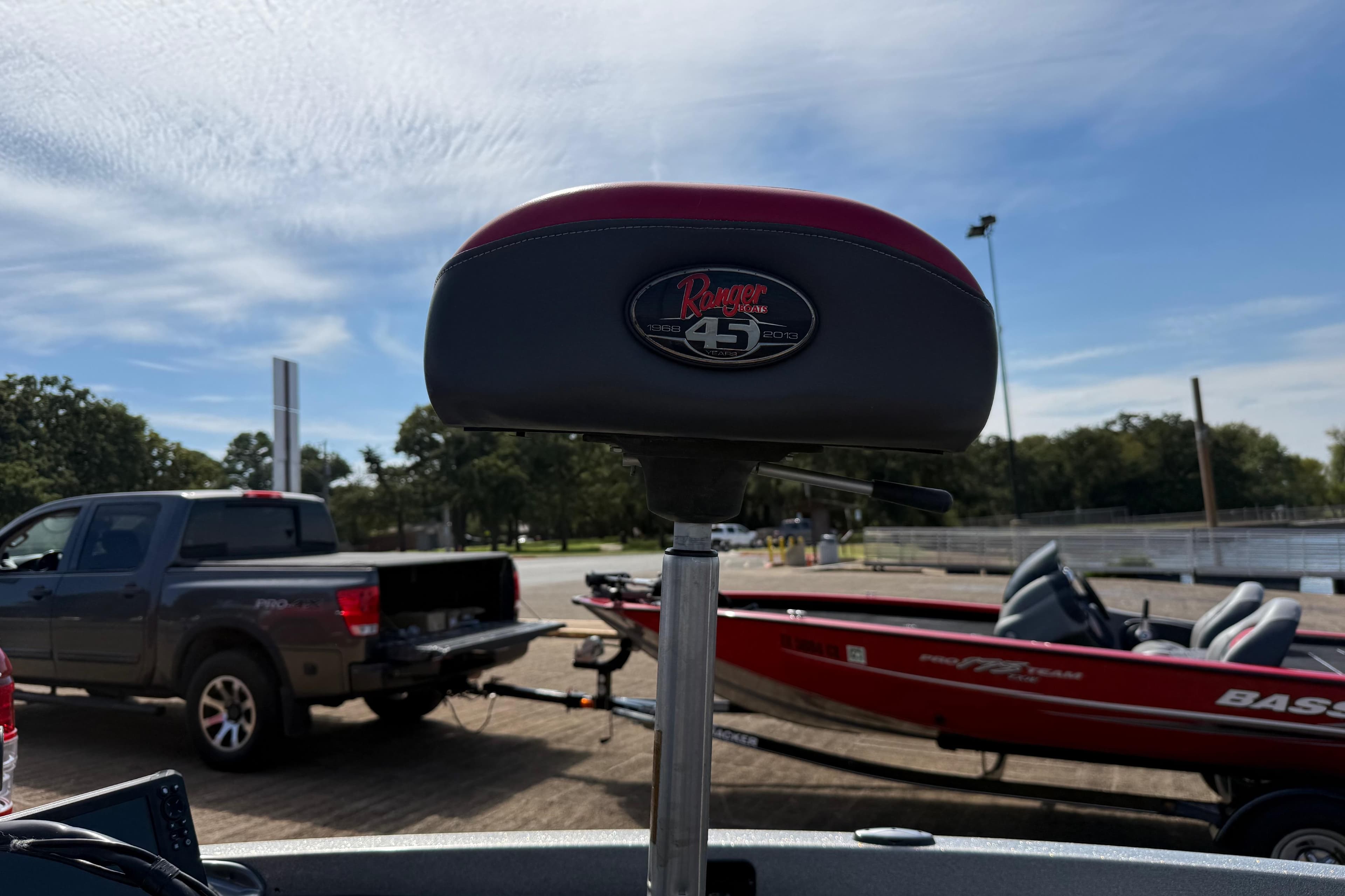 2013 Ranger Z117 boat seat with logo, parked truck and boat in background.