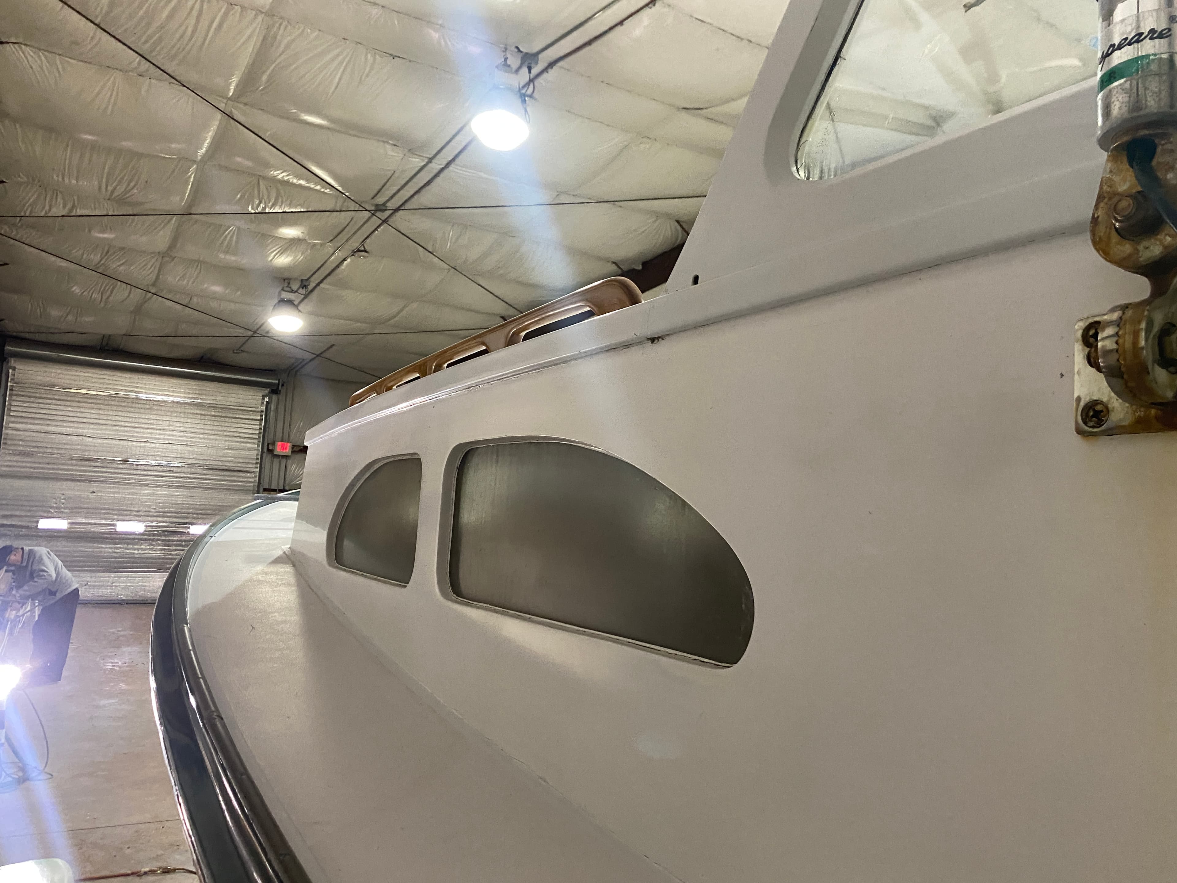 1960 Classic Riverside Boat Co. vessel in a warehouse, showcasing vintage design and craftsmanship.