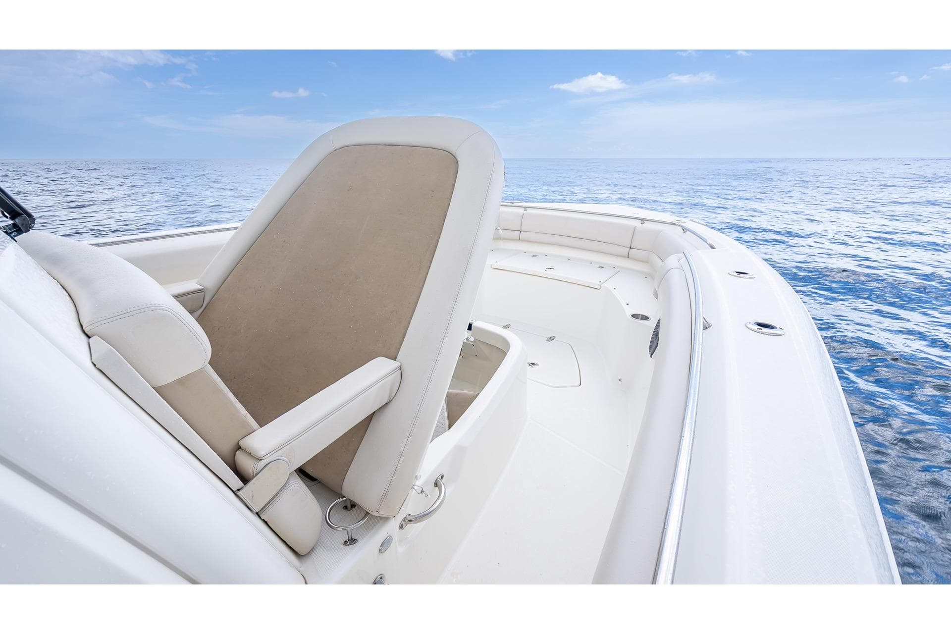 2017 Boston Whaler 330 Outrage boat interior with seating, ocean view, and clear sky.
