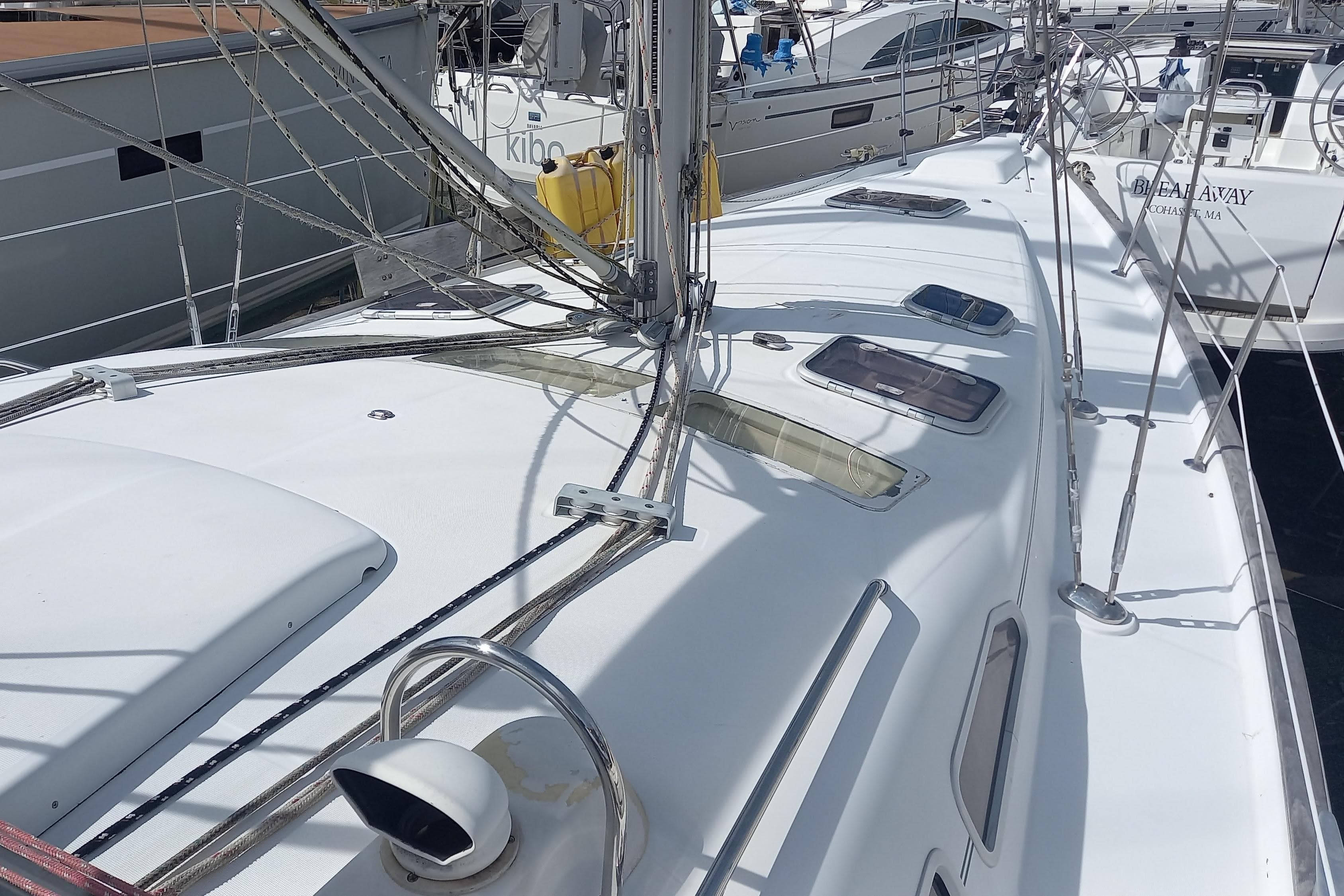 2007 Beneteau 423 sailboat deck with rigging and hatches in a marina.