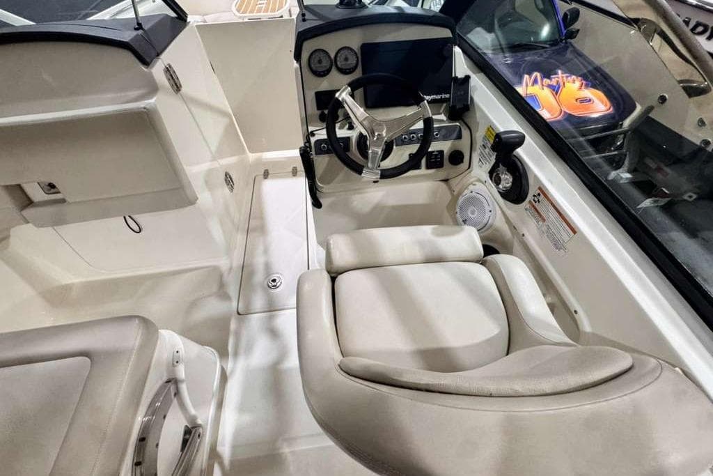 2018 Boston Whaler 230 Vantage boat interior with steering wheel and seating.
