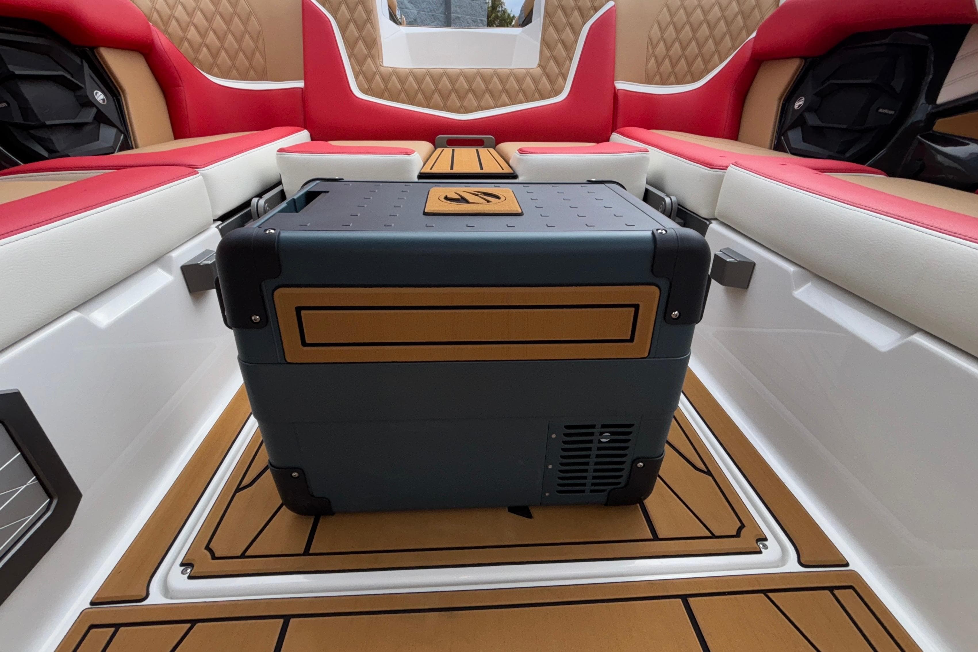 2026 Tigé 24RZX interior with stylish seating and central storage unit.