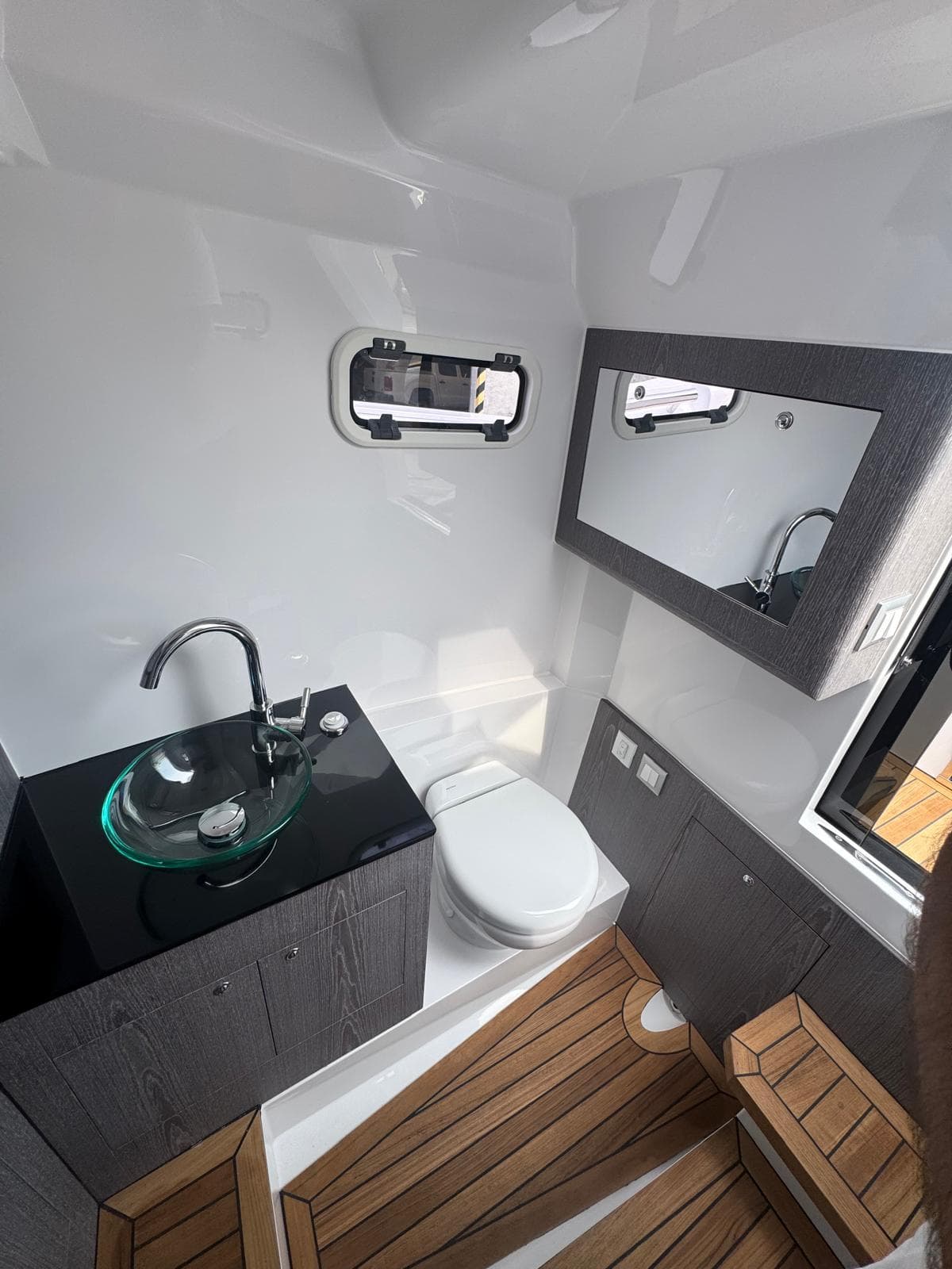 Modern bathroom interior of Pirelli 30 yacht, featuring sleek design and wooden flooring, 2026 model.