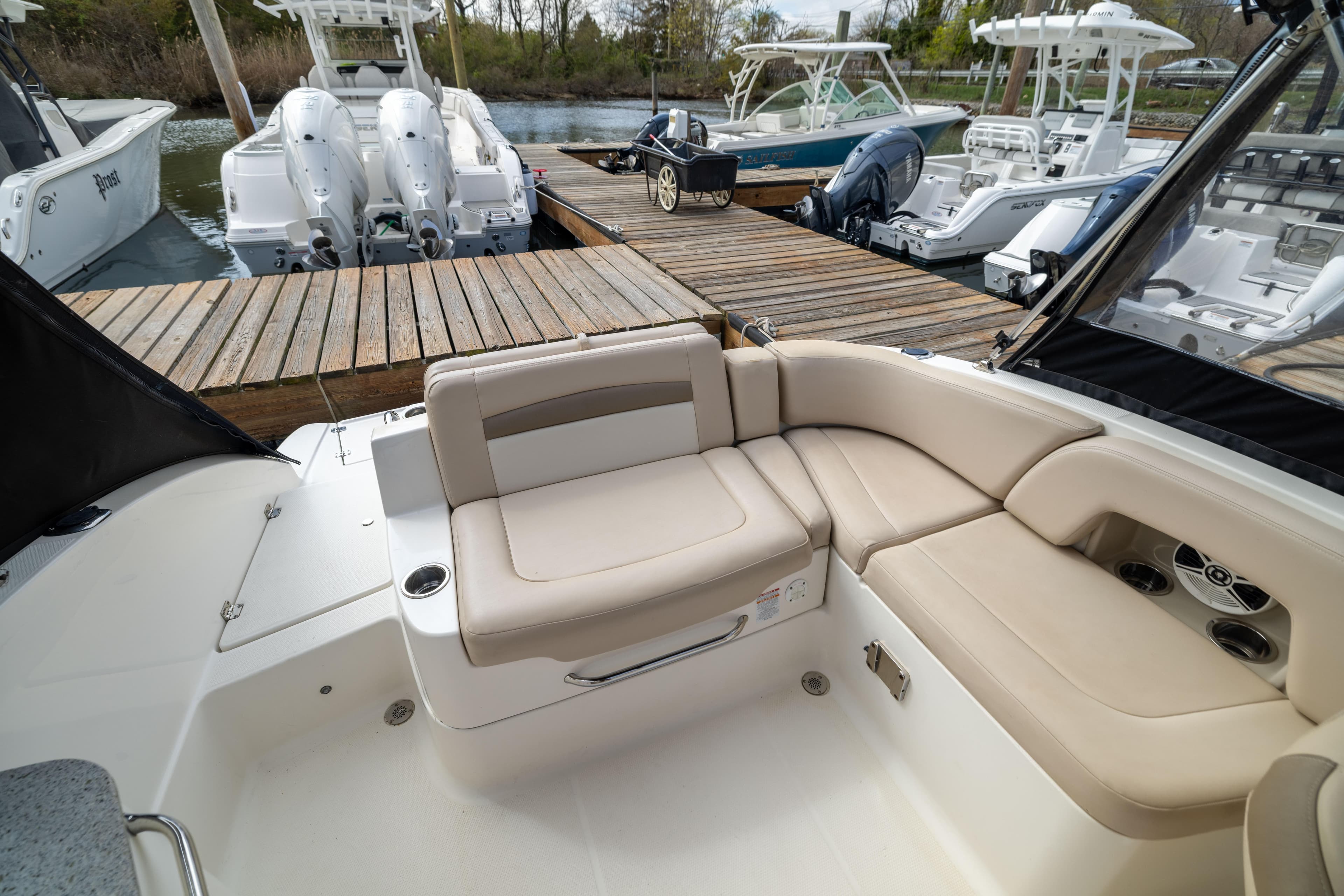 2012 Chaparral 225 SSi boat interior with beige seating at dock.