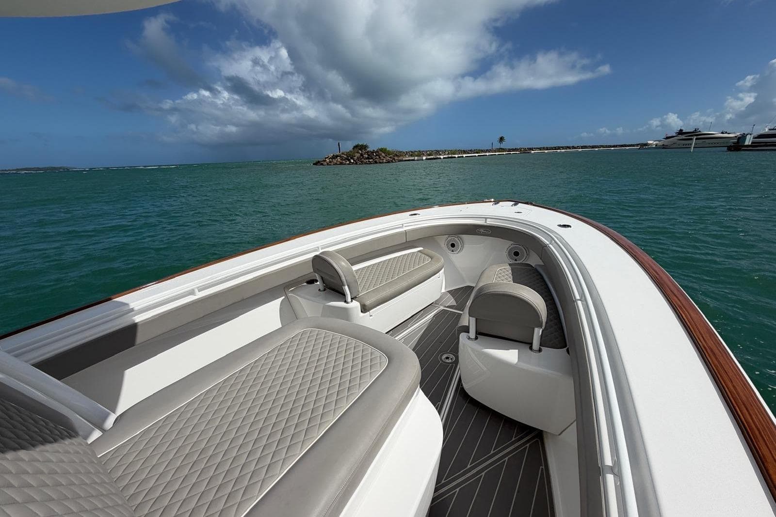 2021 Valhalla Boatworks V-33 on water, featuring elegant seating and scenic ocean view.