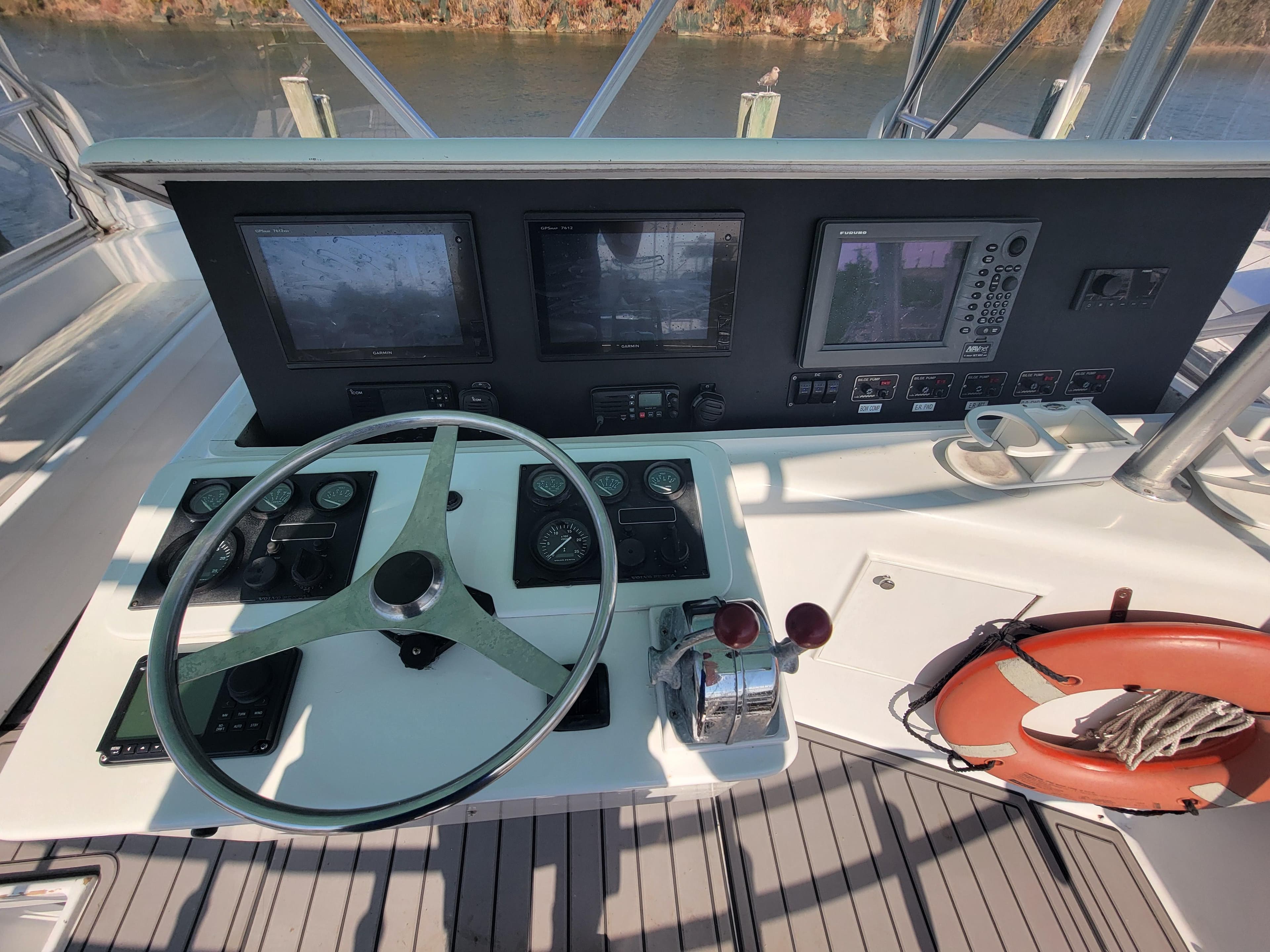 Helm of 1998 Custom Carolina 45 Willis Boatworks with navigation instruments and steering wheel.